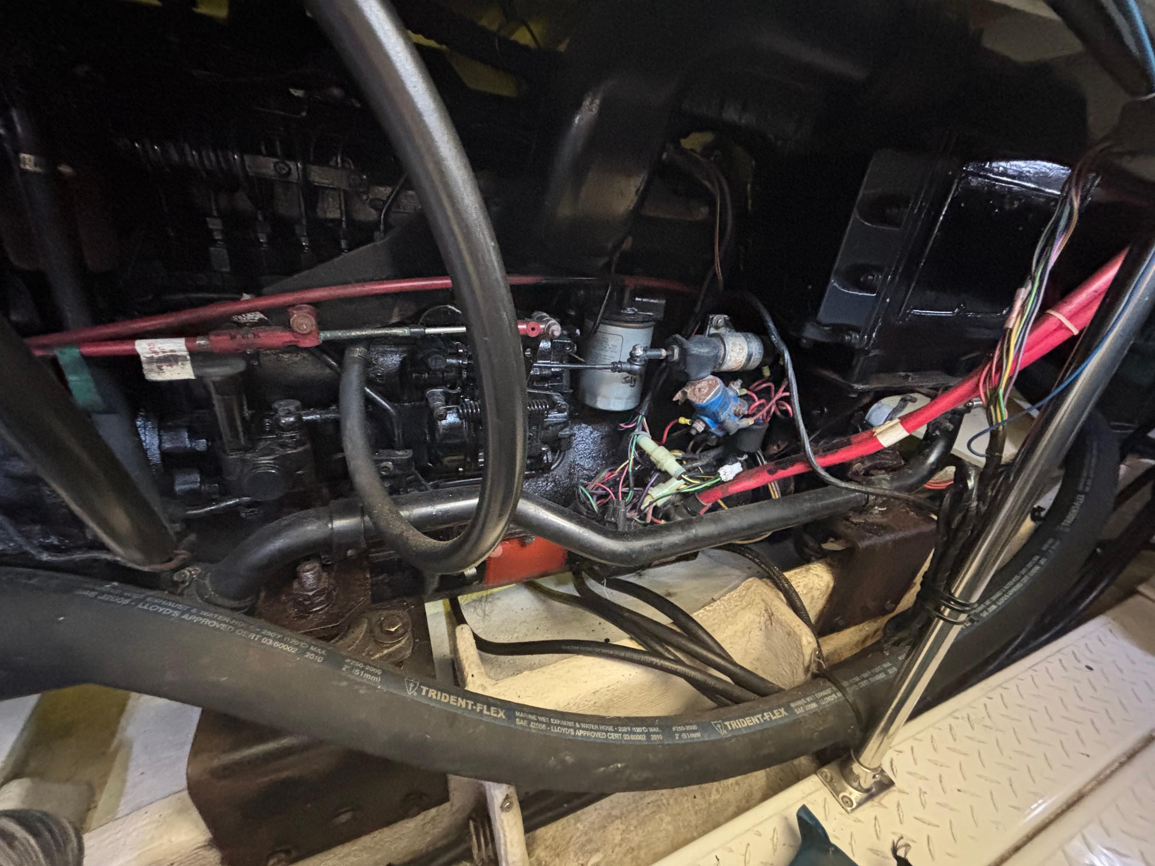 Engine compartment of a 1994 Bayliner 4700 boat, showing wiring and hoses.