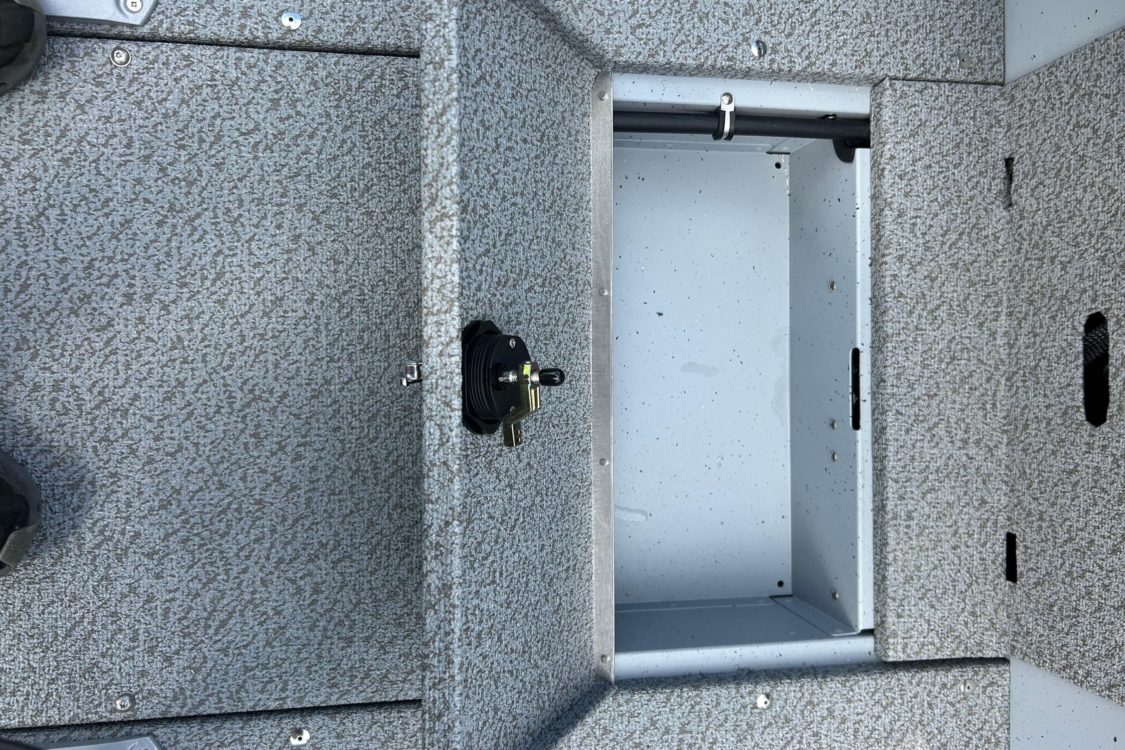 Open storage compartment in 2026 Lund 2075 Alaskan Sport boat interior.