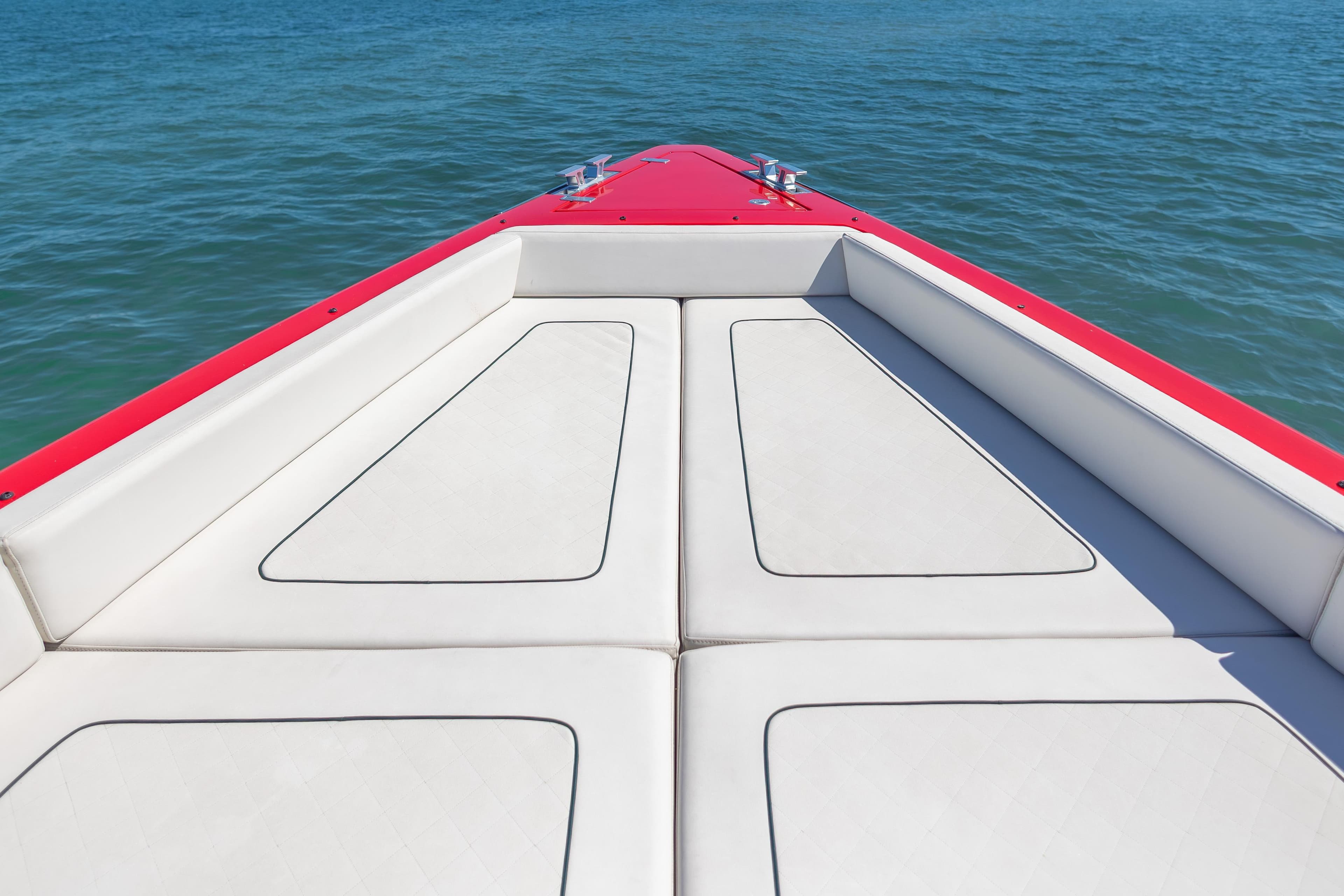 Bow of 2021 Wally 48 yacht with red trim on calm blue water.