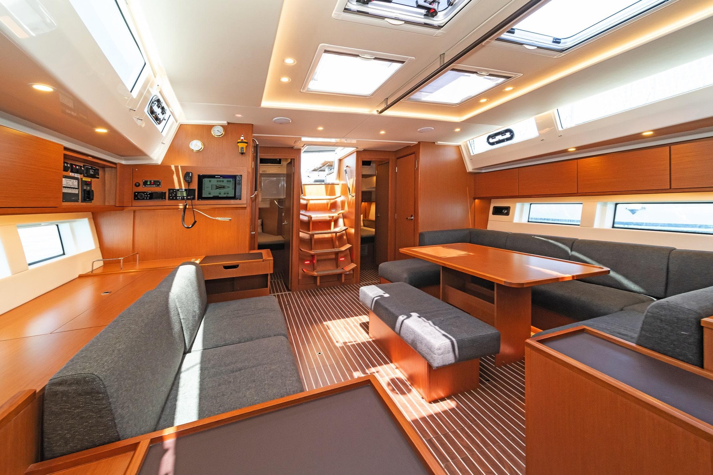 Luxurious interior of 2021 Bavaria C57 Style yacht with modern furnishings and ample natural light.
