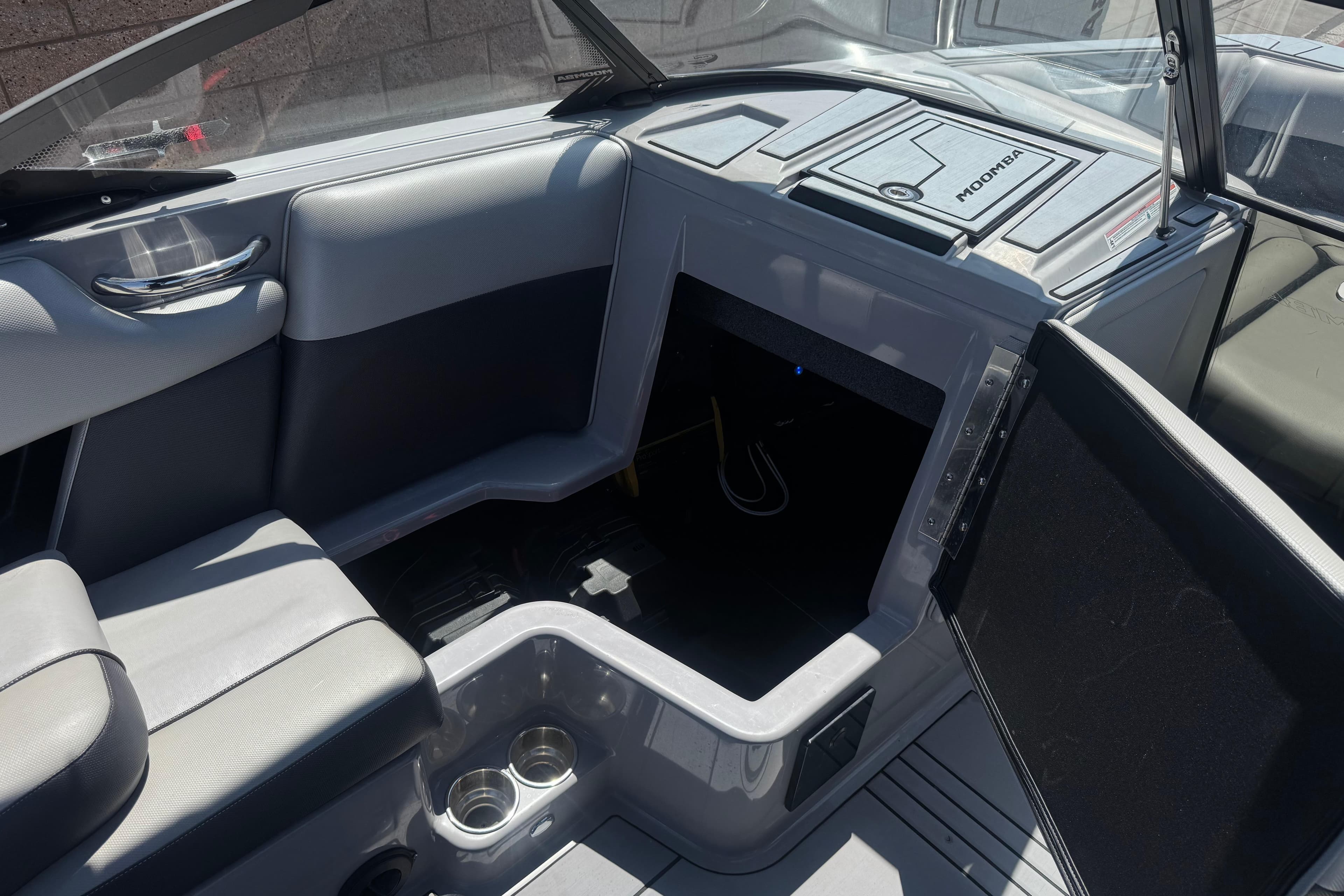 Interior of a 2022 Moomba Max boat featuring seating and storage compartments.