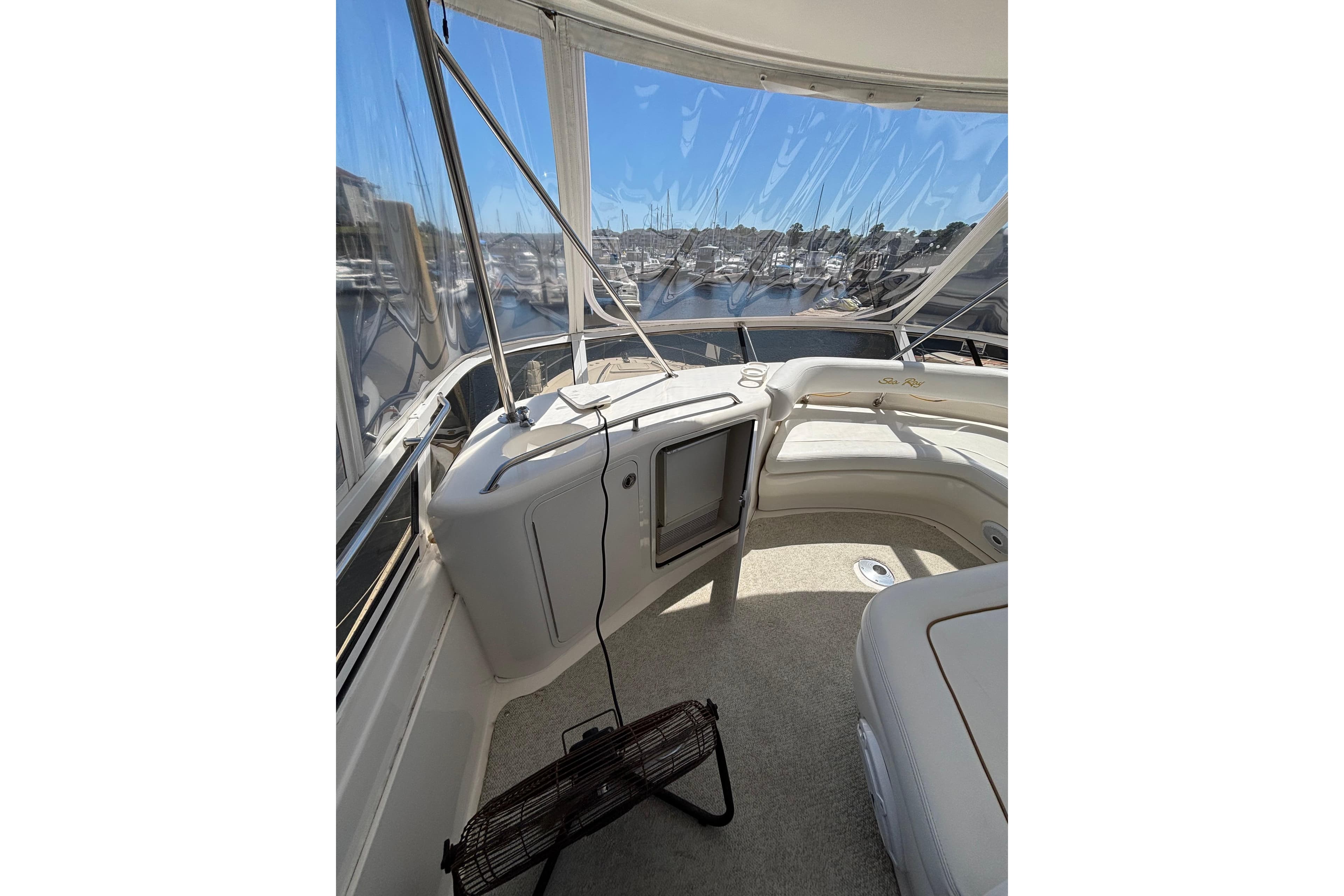 1999 Sea Ray 480 Sedan Bridge interior with panoramic marina view.