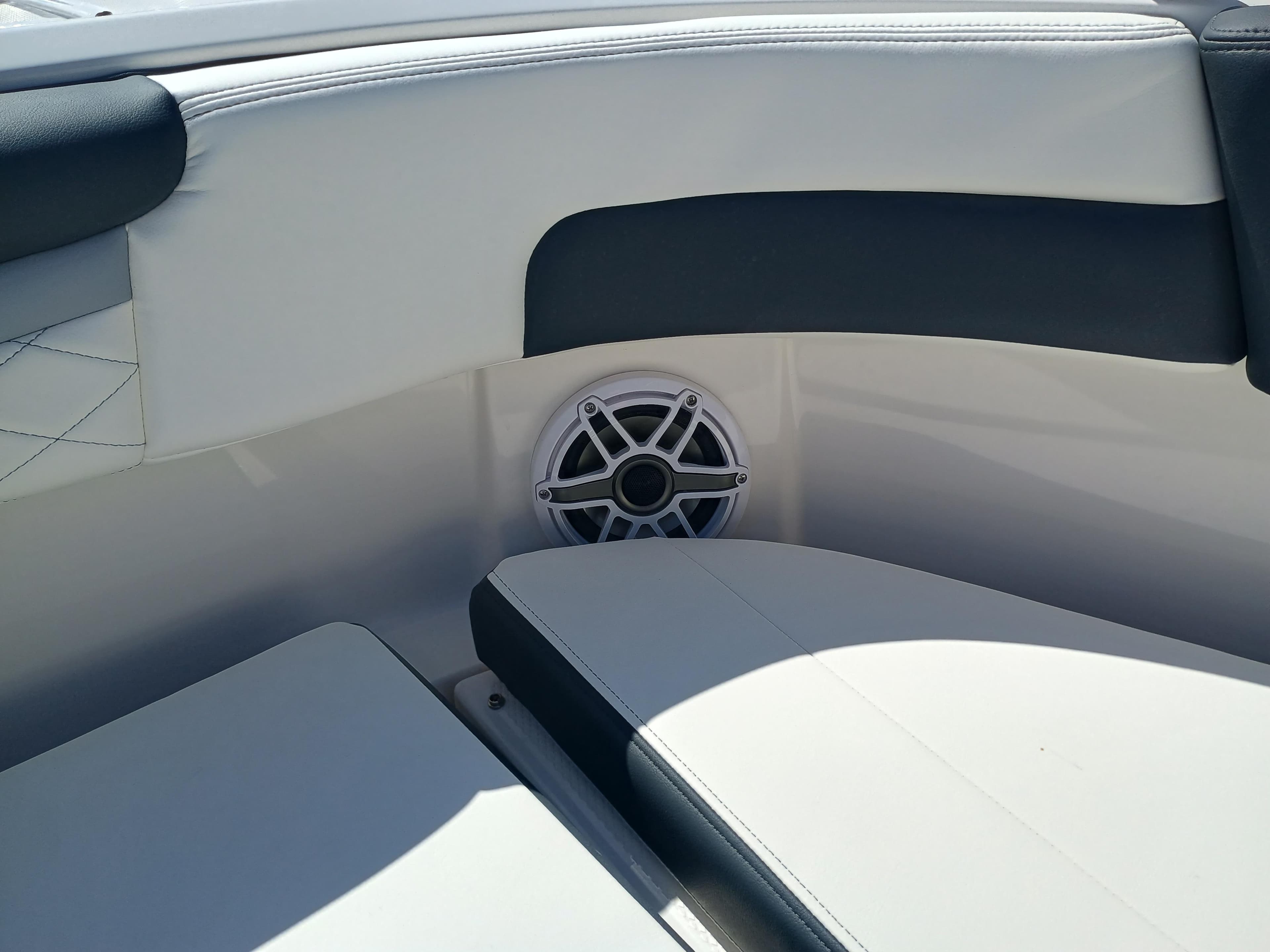 2025 Robalo R257 Dual Console boat interior with speaker and cushioned seating.