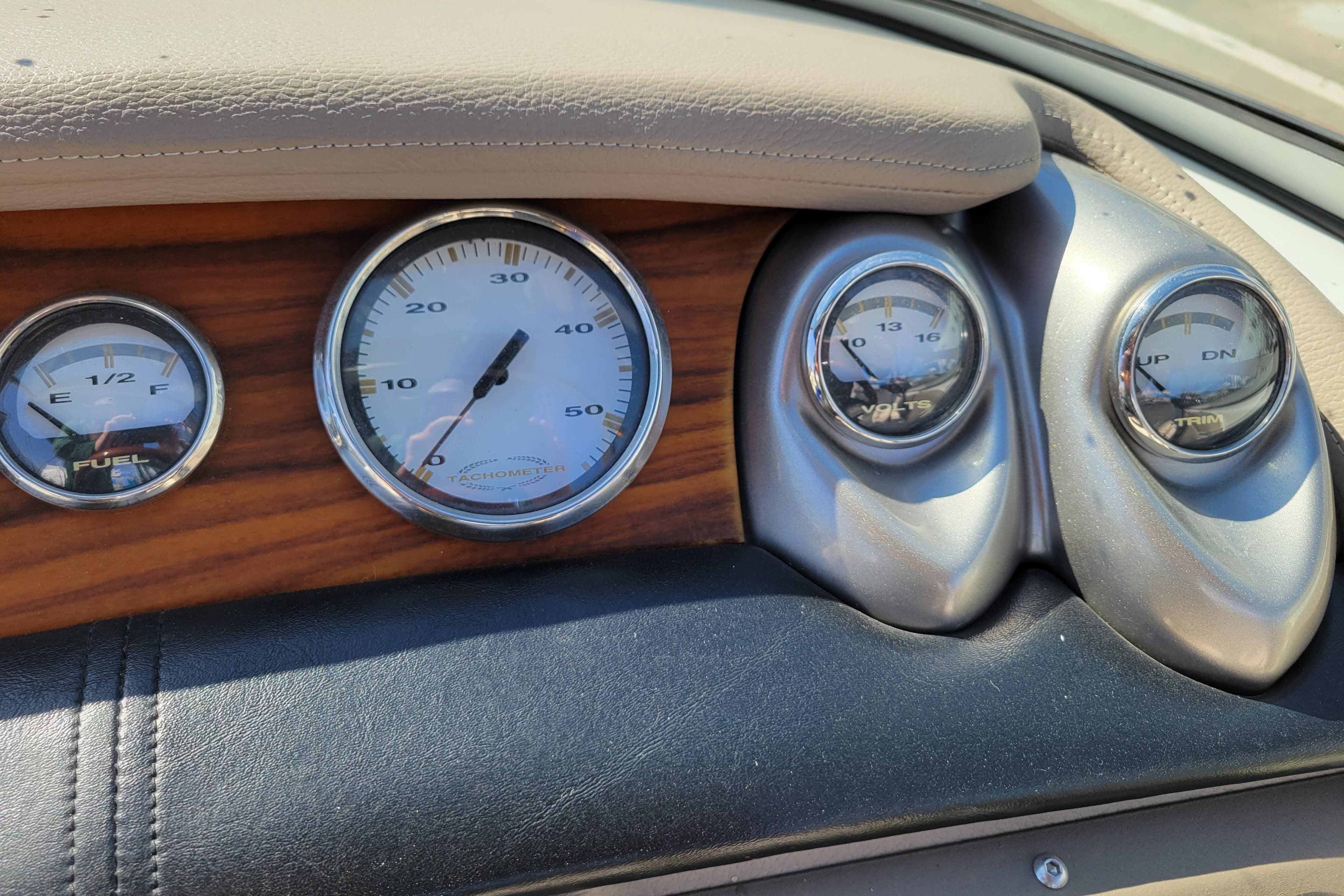 Dashboard gauges of a 2006 Cobalt 250 boat, featuring fuel, tachometer, volts, and trim indicators.