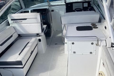 2021 Blackfin 272DC boat interior with white seating and control panel.