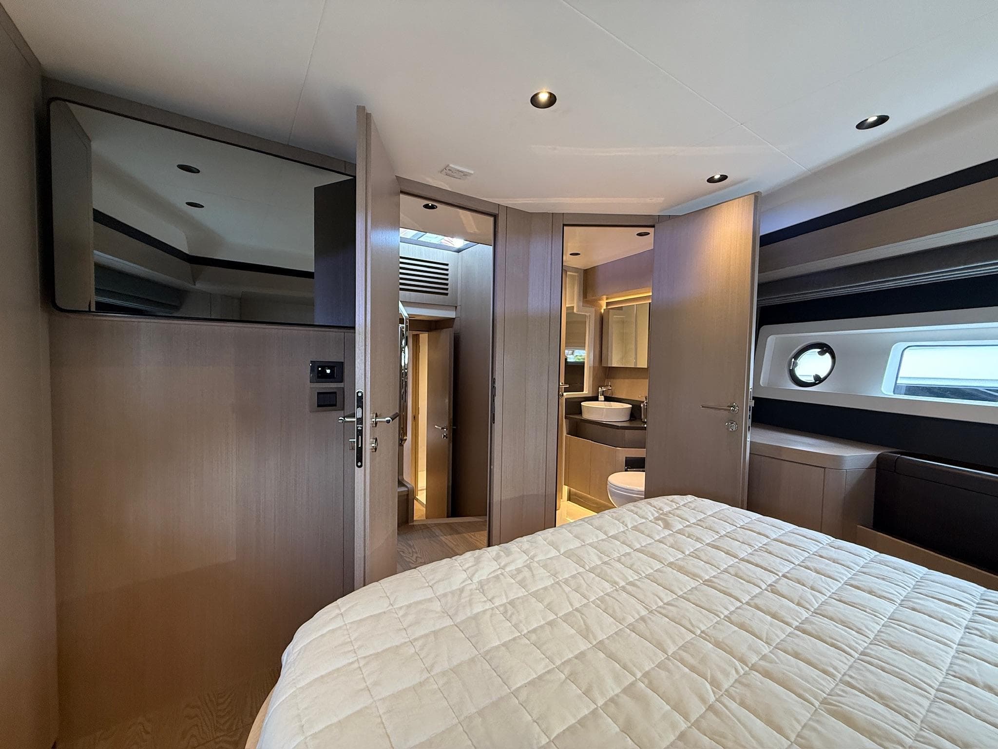 Luxurious interior of 2025 Sirena 48 Coupe yacht with modern bedroom and ensuite bathroom.