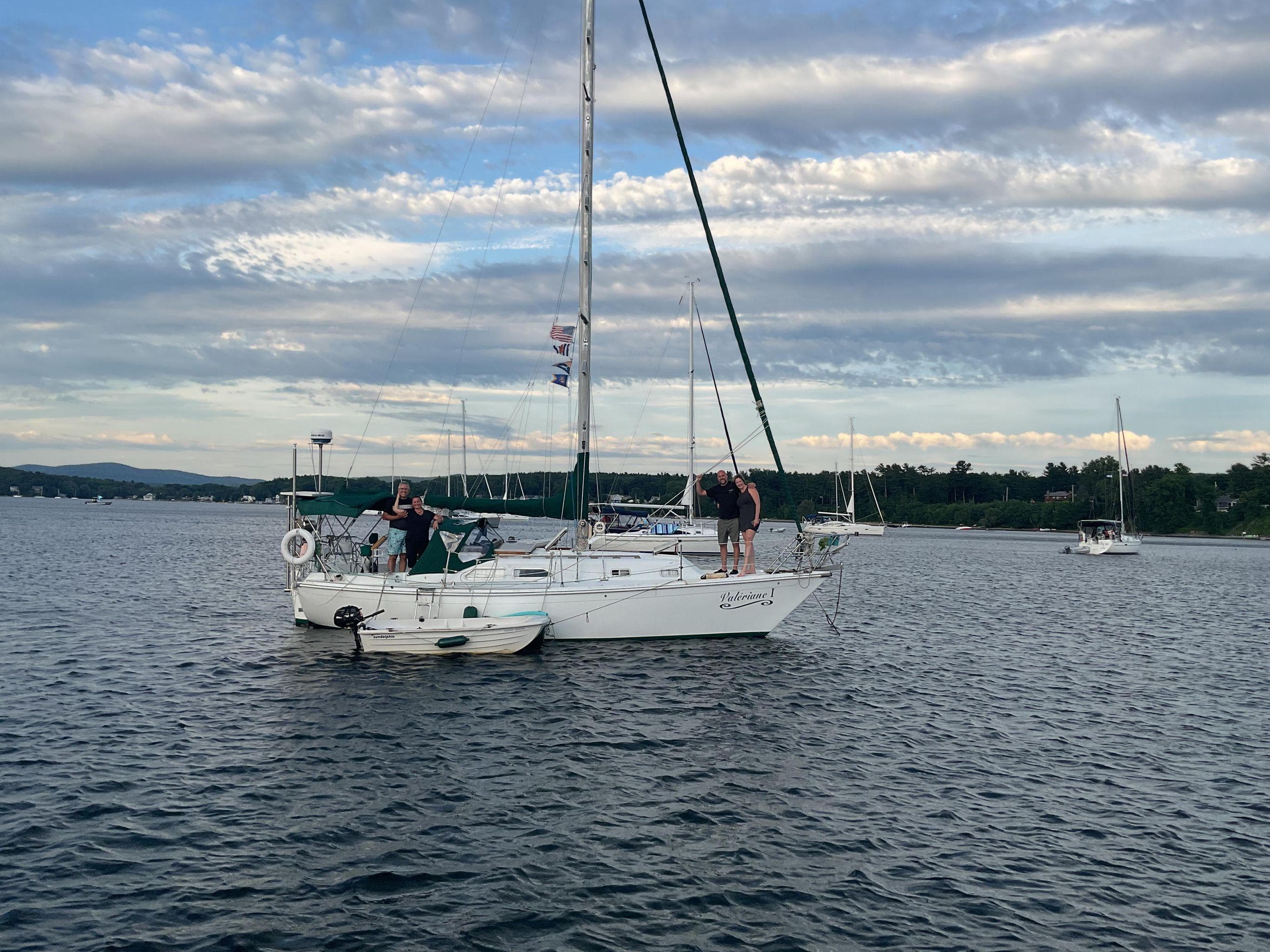 1978 Ericson 30-2 sailboat on calm water under a cloudy sky.
