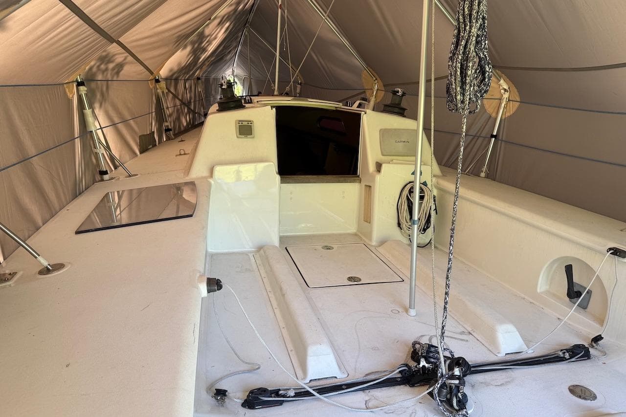 2007 Hallett 33 boat interior under a protective tent, showcasing deck and rigging.