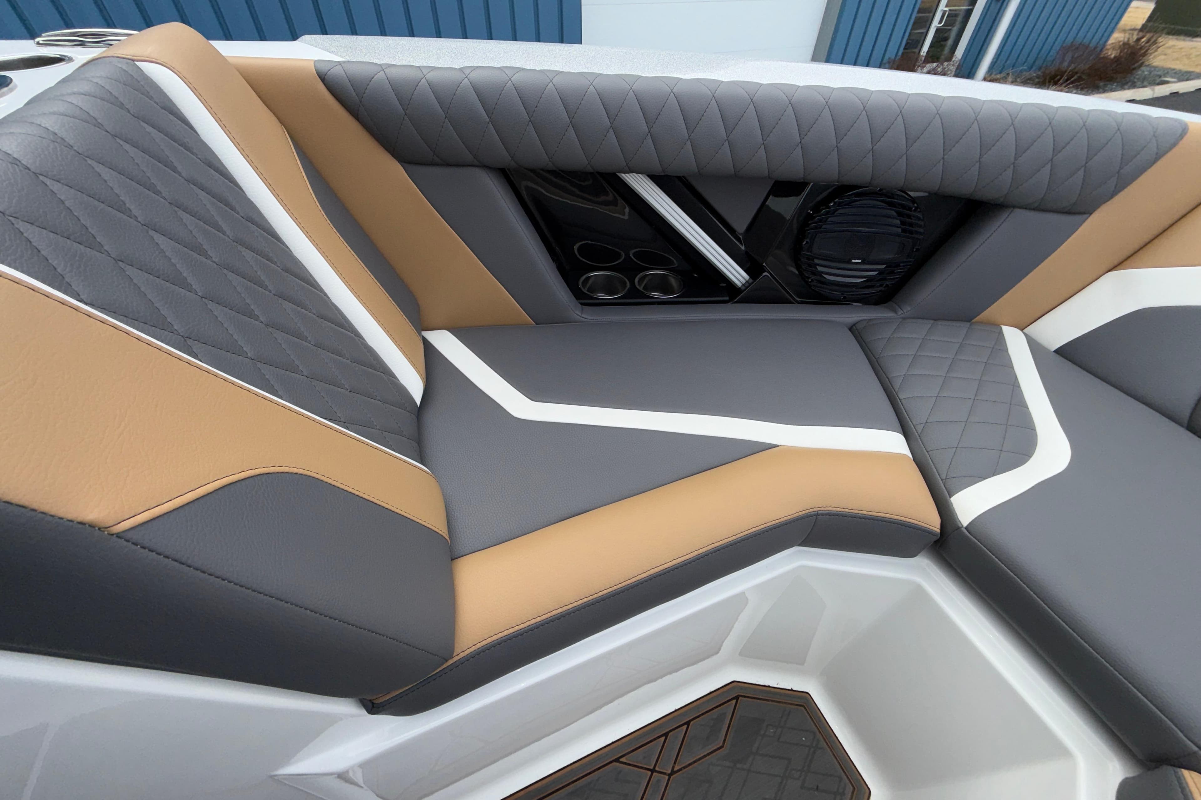 2023 Tigé 23ZX boat interior with stylish gray and tan seating, featuring quilted design.