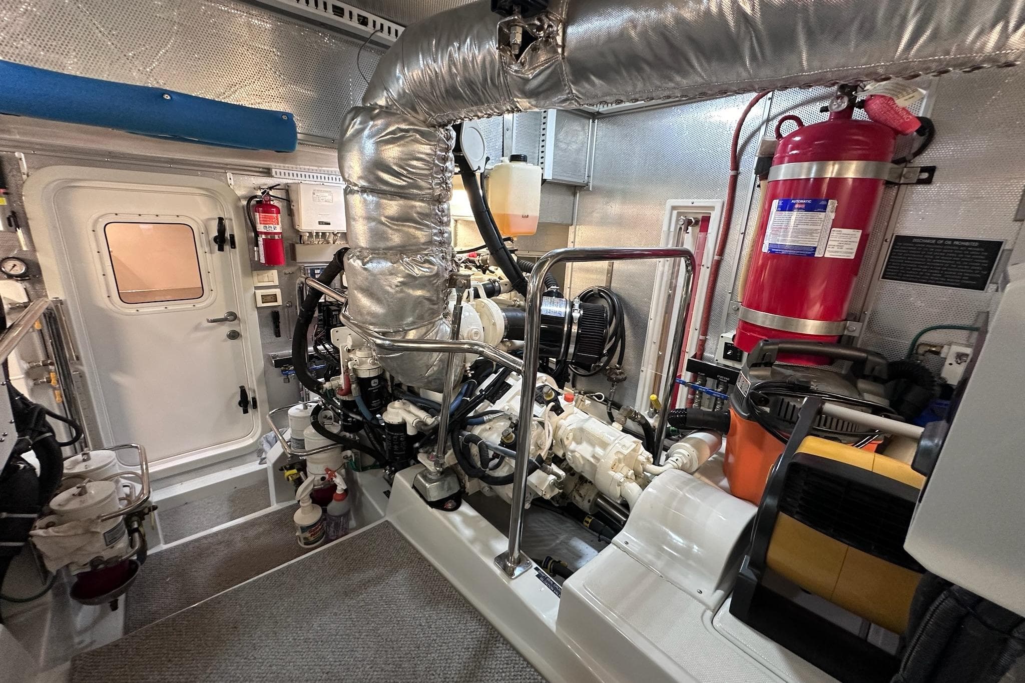 Engine room of 2016 Nordhavn 60 yacht, featuring machinery and safety equipment.