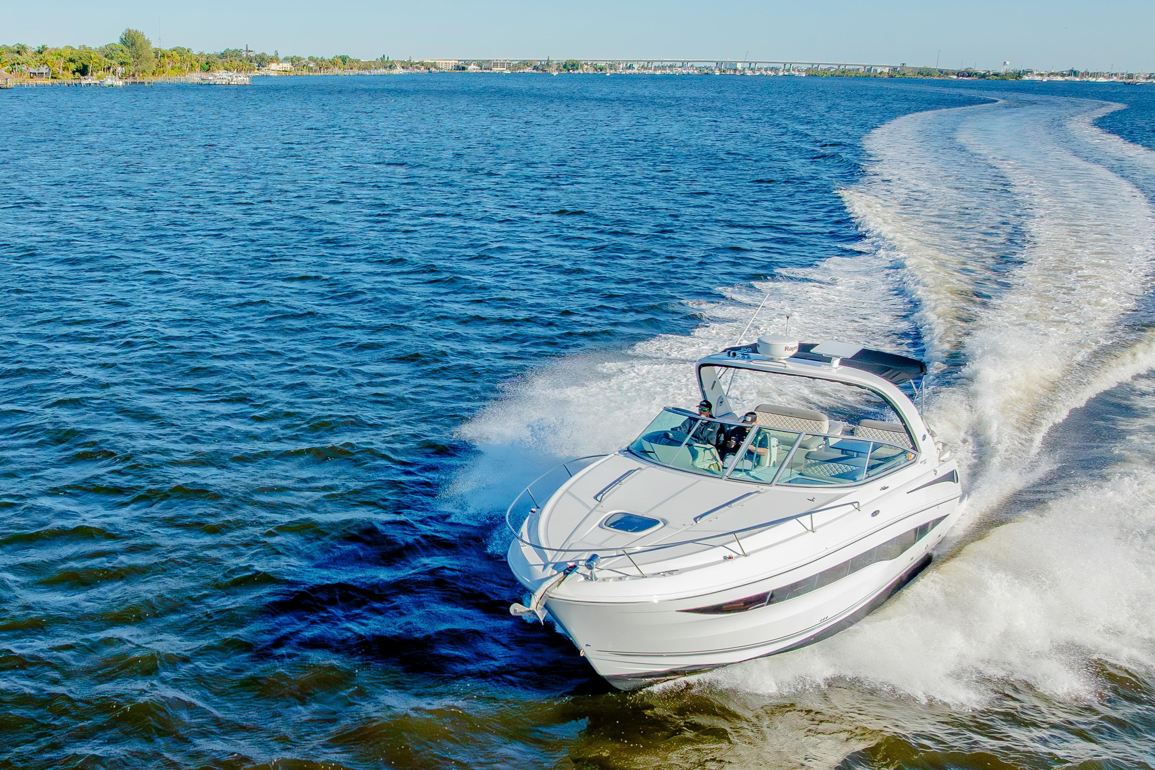 2013 Sea Ray 370 Venture cruising on open water, leaving a wake behind.