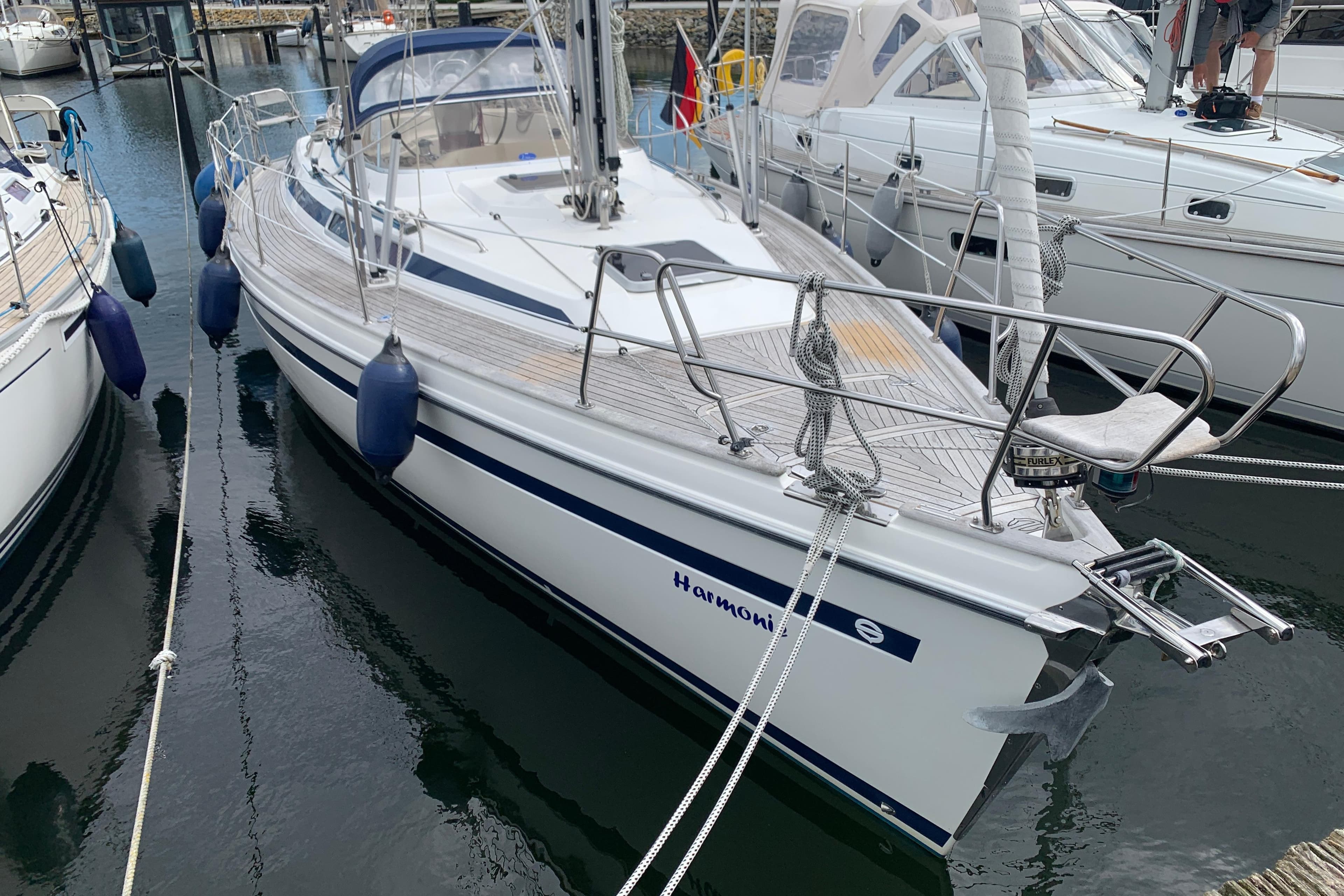 Sailboat Sunbeam 37, year 2000, docked in marina with fenders and ropes.