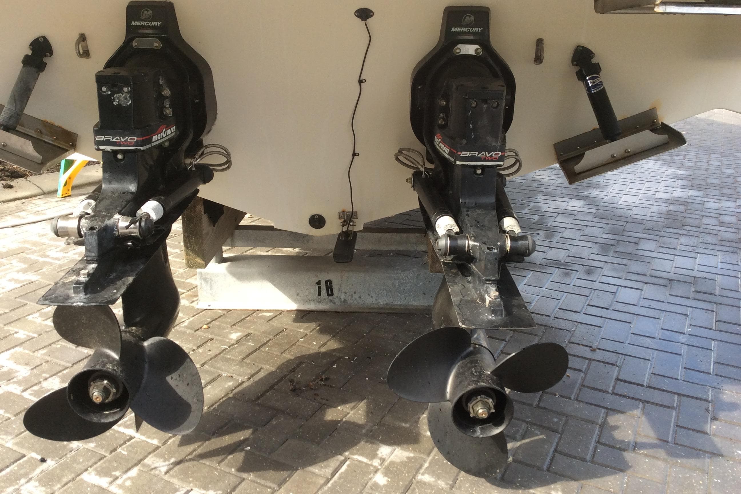 Maxum 2800 SCR 2000 boat with dual propellers on a paved surface.