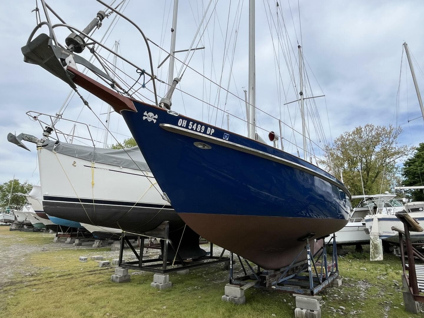 1978 Cheoy Lee Offshore 33 sailboat on stands, blue hull, outdoor storage.