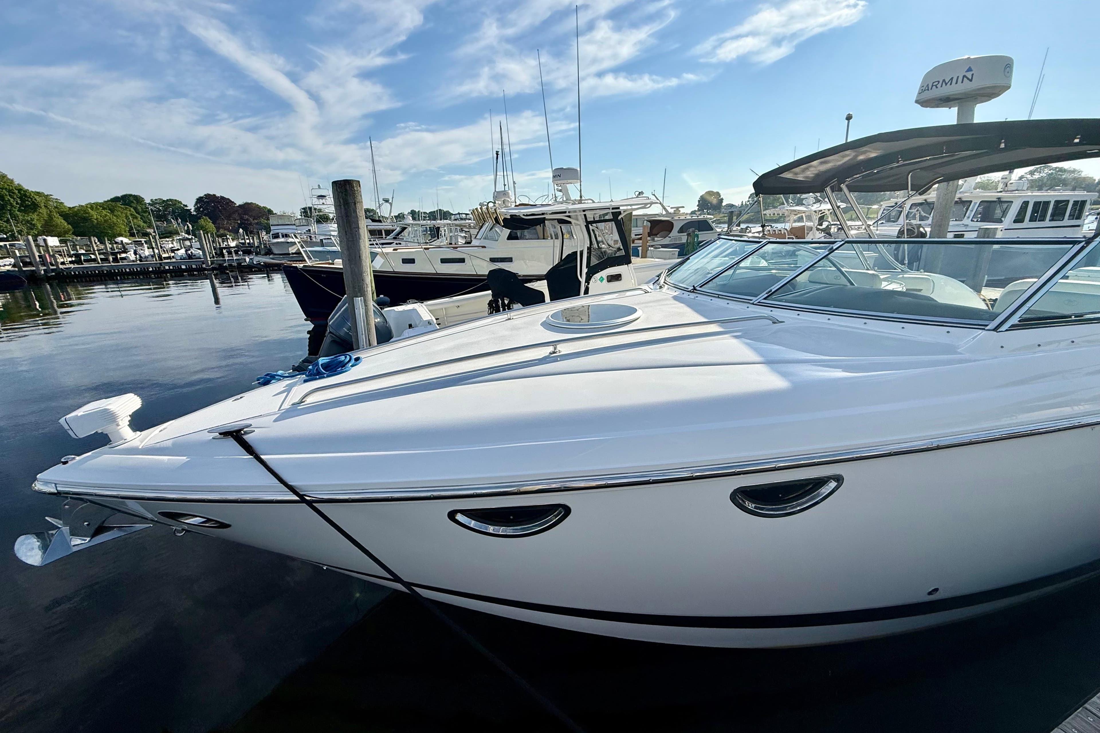 2007 Cobalt 323 boat docked at marina under clear blue sky.