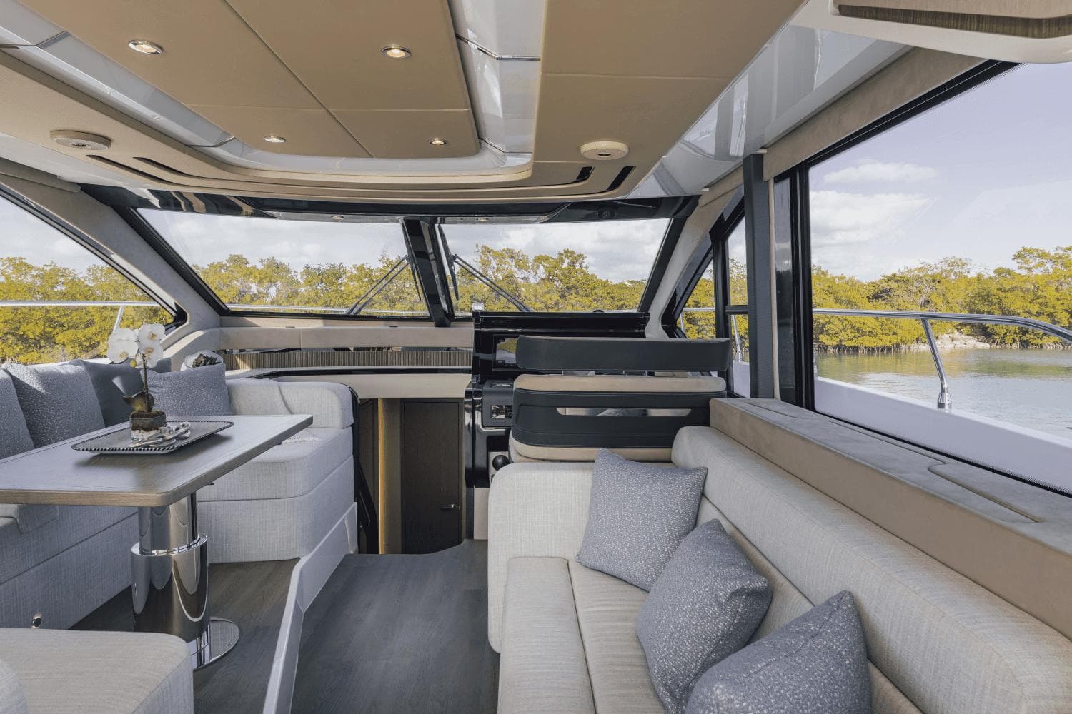 Luxurious interior of 2025 Cruisers Yachts 57 Fly with modern seating and panoramic windows.