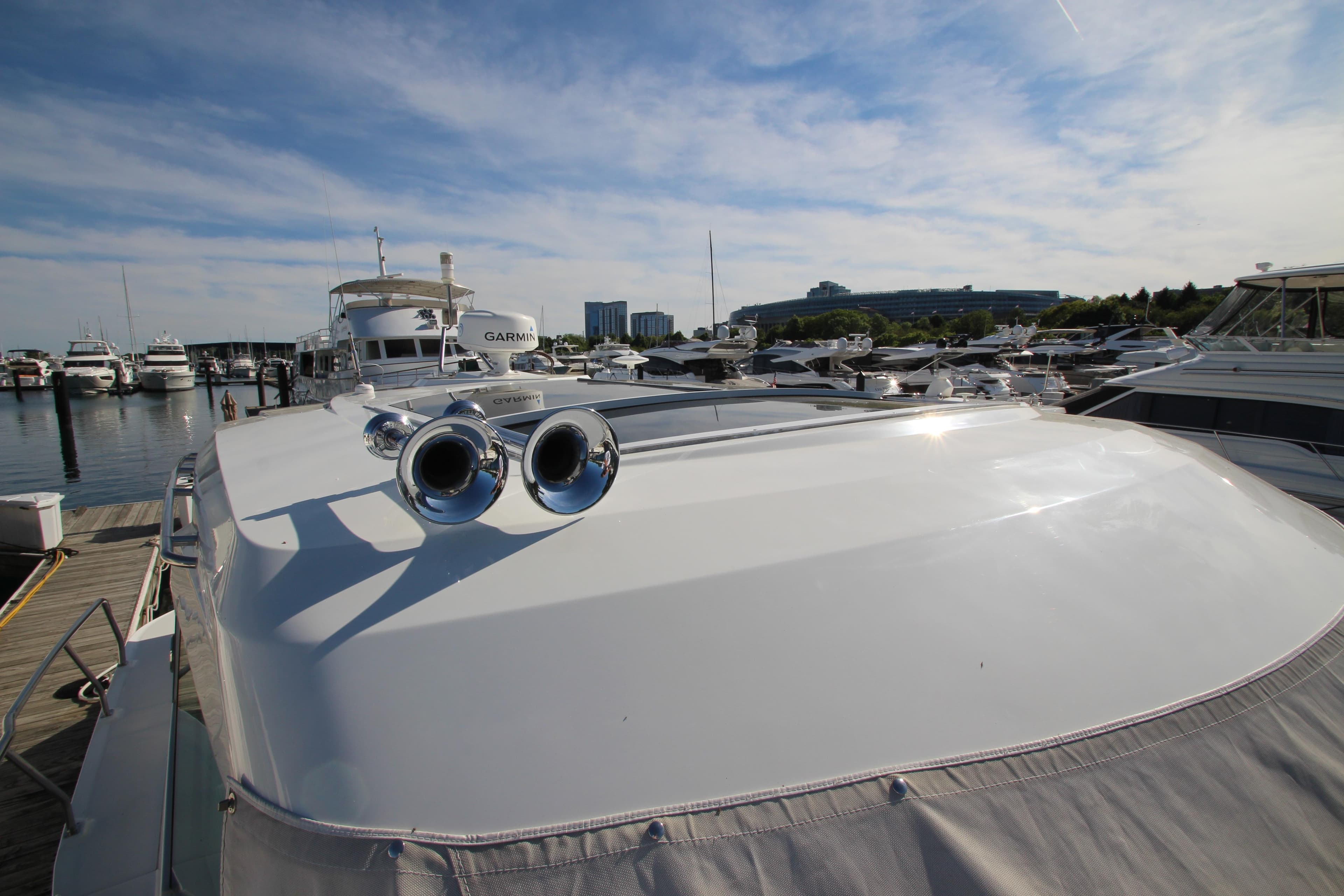 2014 Cruisers Yachts 45 Cantius docked at marina under clear blue sky.
