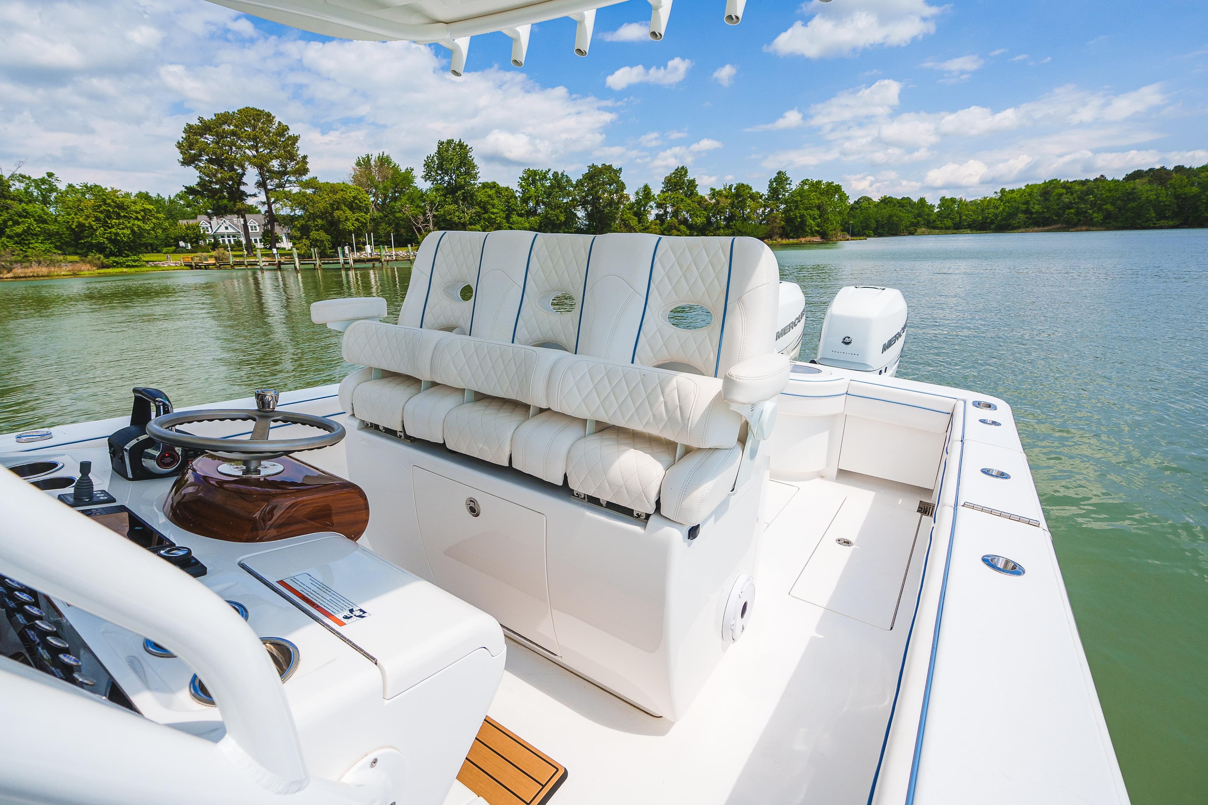 2022 Valhalla Boatworks V-33 with luxurious seating on a serene lake.