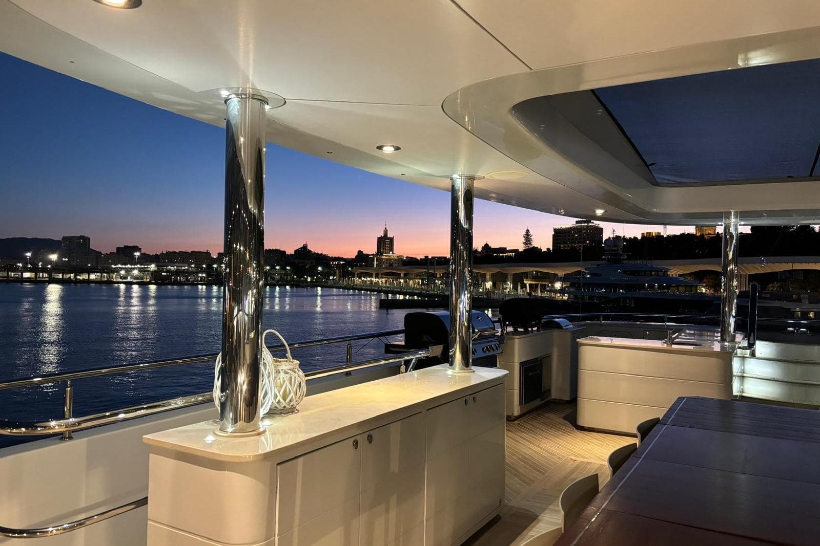 Luxurious LOGOS MARINE Curvelle yacht deck at sunset, 2013 model, overlooking serene waterfront.