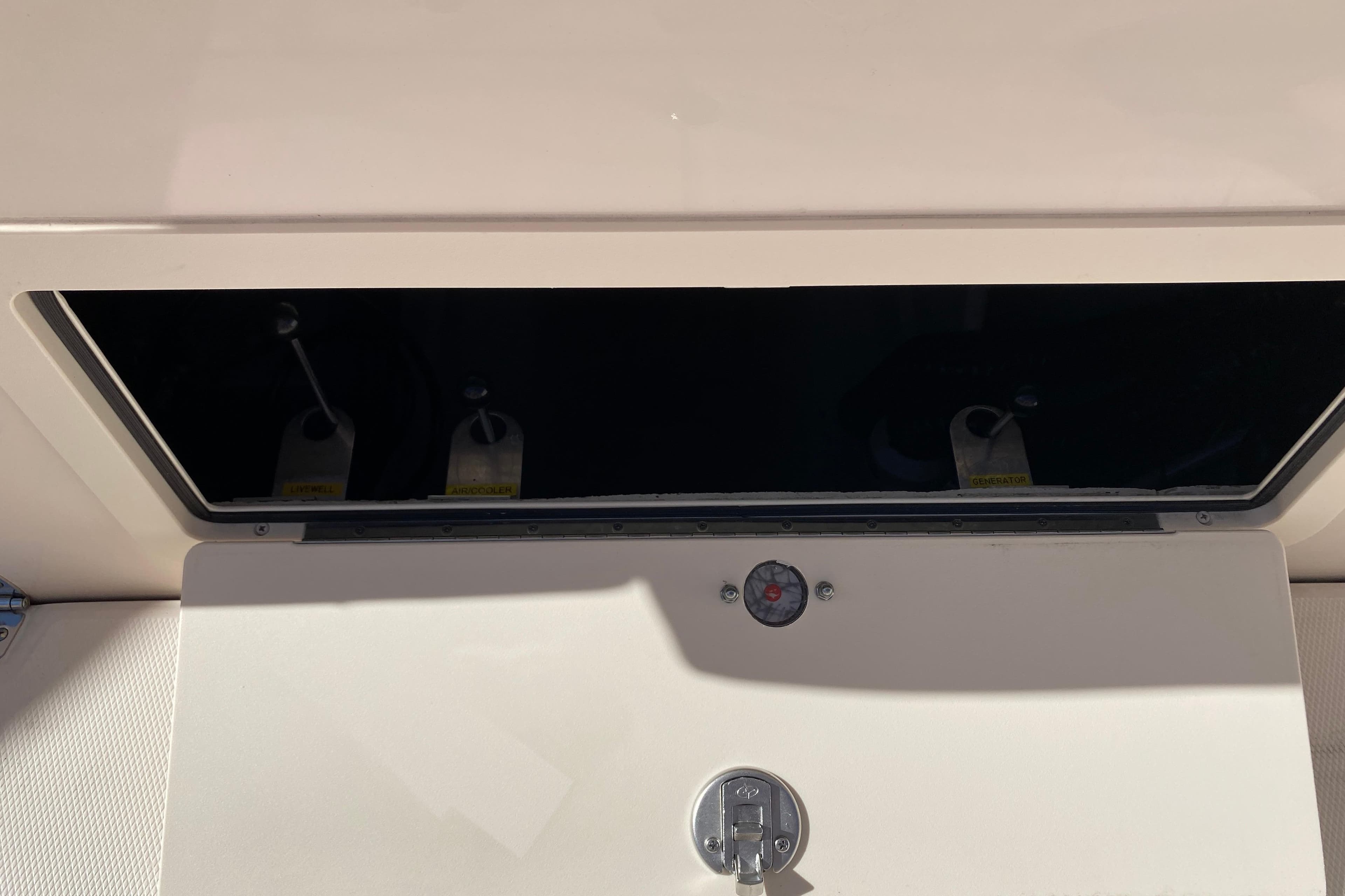 2026 Grady-White Canyon 336 storage compartment with latch and shadow detail.