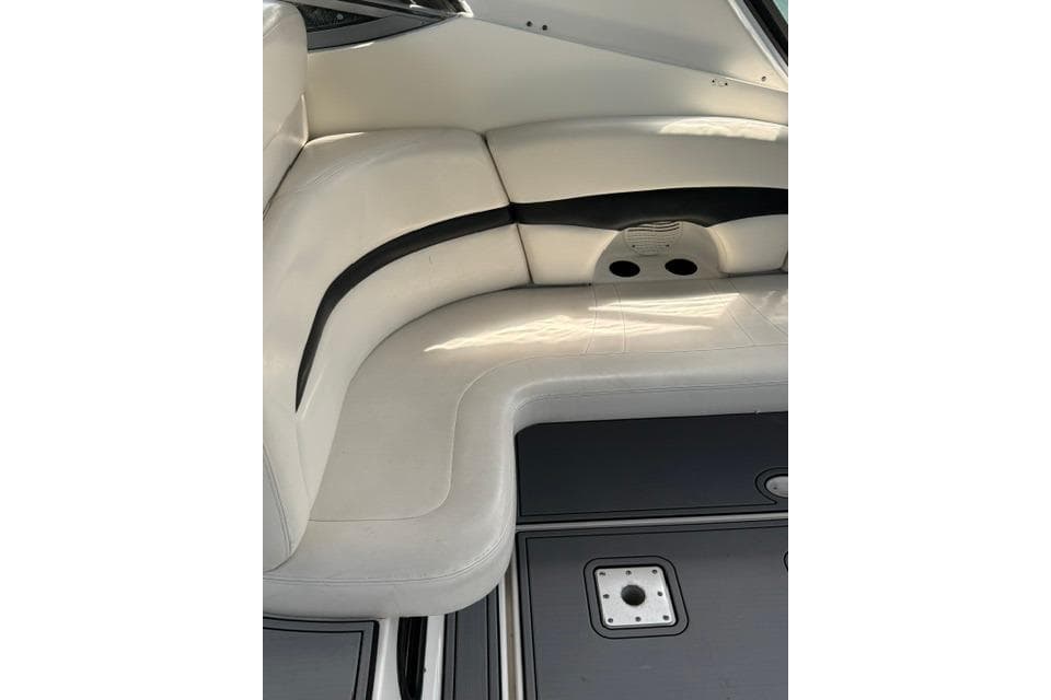 Interior seating of 2002 Chaparral 350 Signature boat, featuring white upholstery and sleek design.
