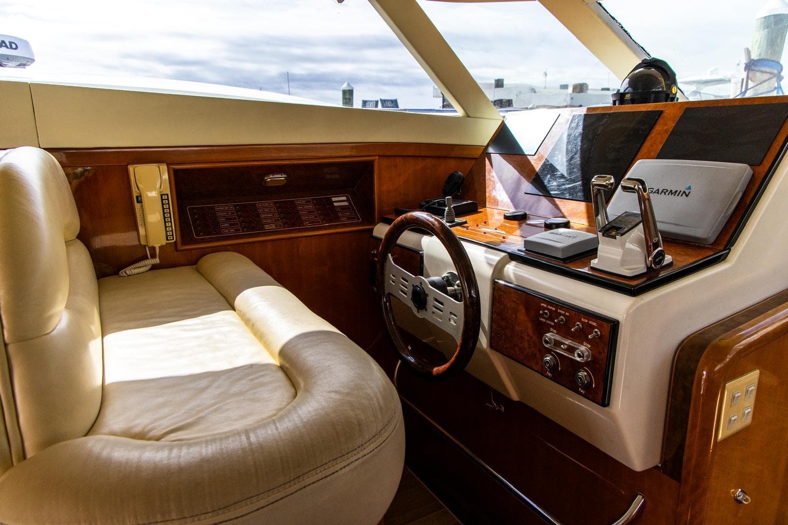 Luxurious 2002 Dyna 50 yacht interior with leather seating and advanced navigation equipment.
