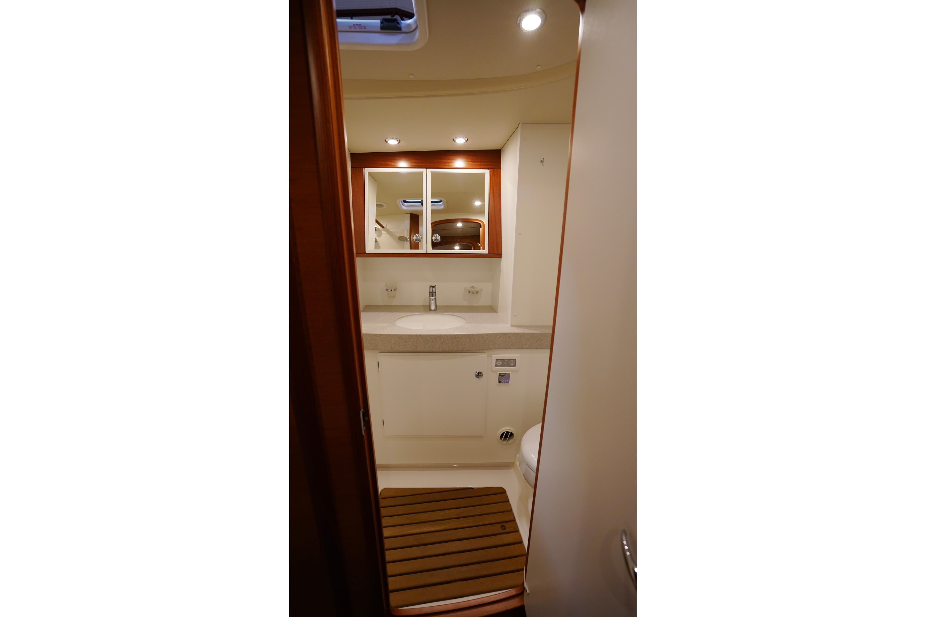 2020 Hallberg-Rassy 57 yacht bathroom with modern fixtures and wooden accents.