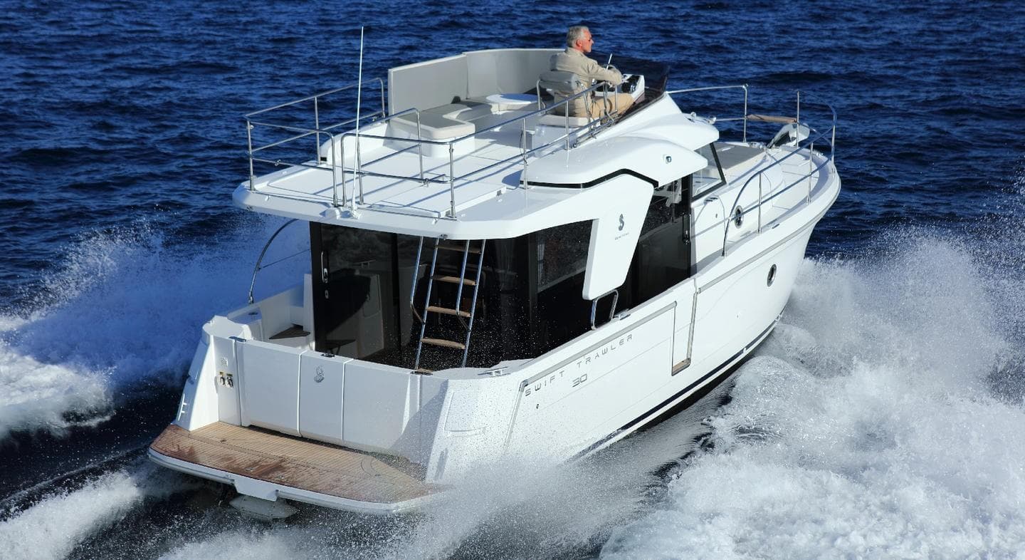 Manufacturer Provided Image: 2020 Beneteau Swift Trawler 30 cruising on open water, showcasing sleek design and performance.