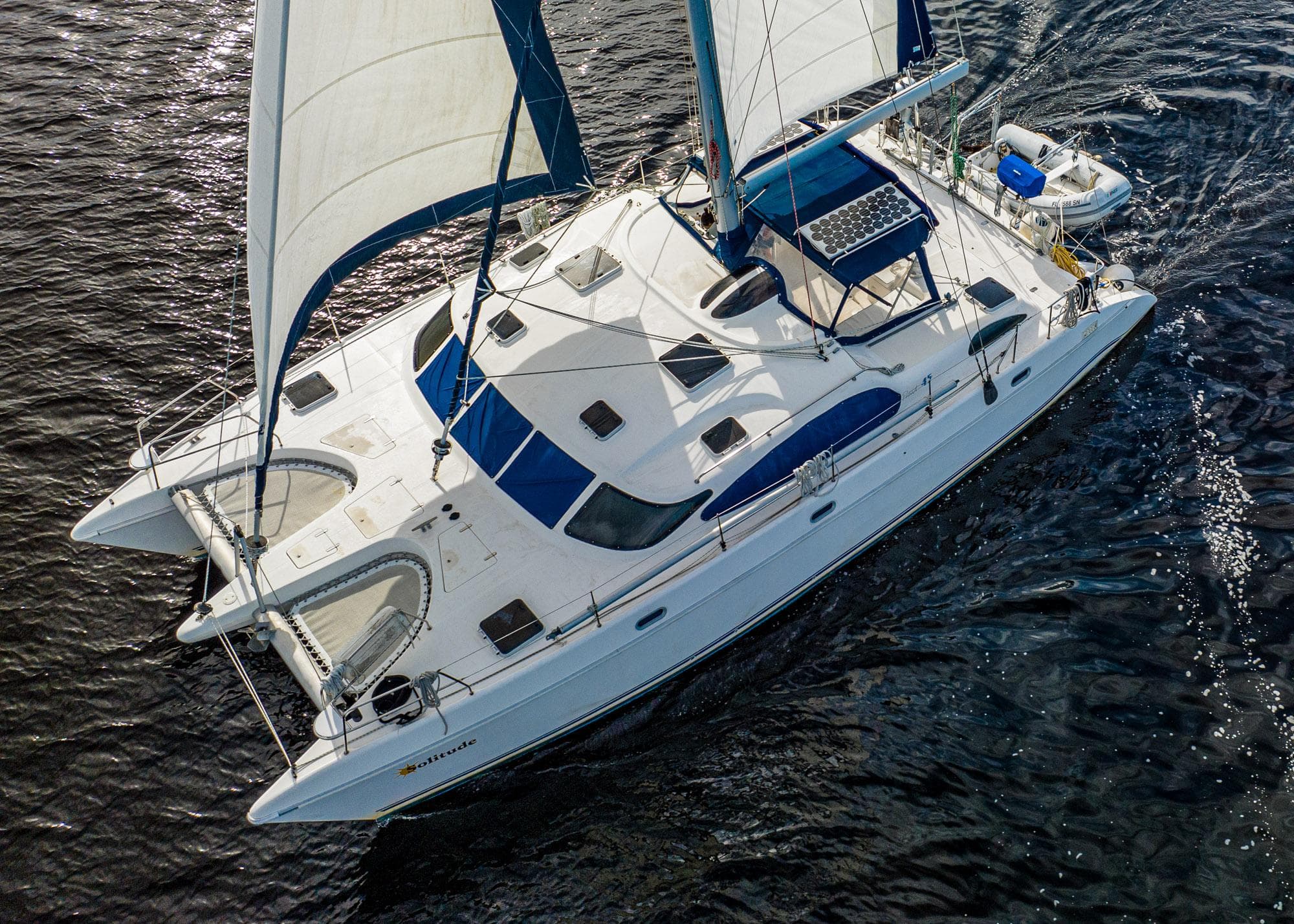 Aerial view of a 1995 Prout 45 catamaran sailing on open water.