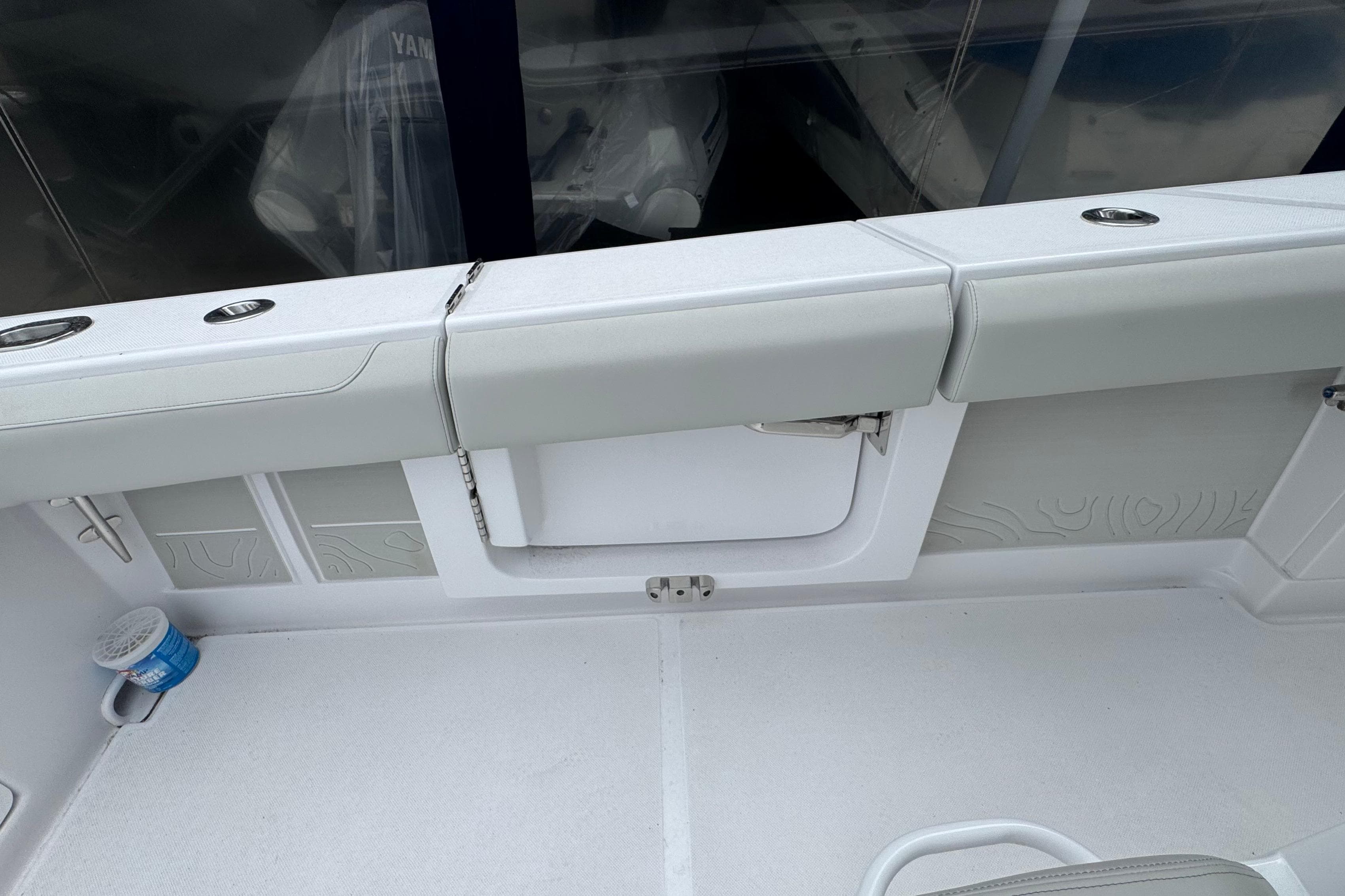 Interior view of a 2026 Jupiter 30 boat, featuring sleek seating and storage compartments.