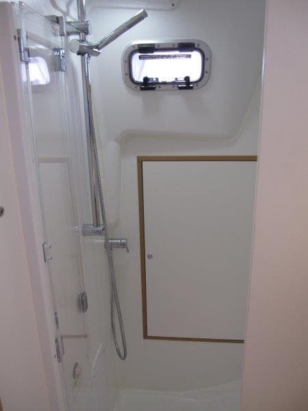 2025 Jeanneau Sun Odyssey 350 yacht bathroom with shower and porthole window.