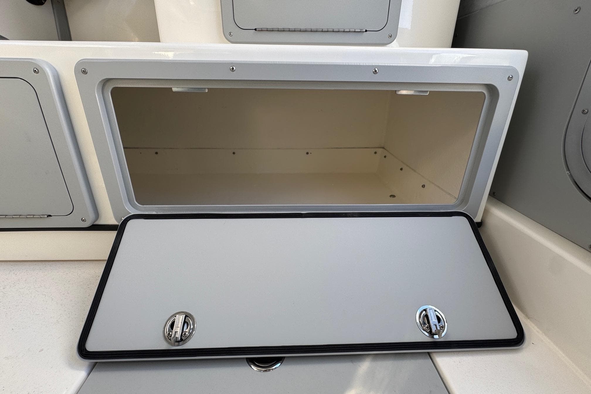Open storage compartment on 2026 Defiance Admiral 250 EX boat.