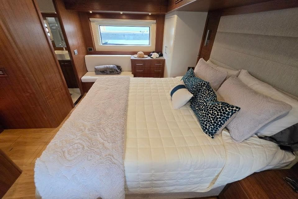 Luxurious bedroom interior of 2024 Sirena 58 Flybridge MY yacht with elegant bedding.