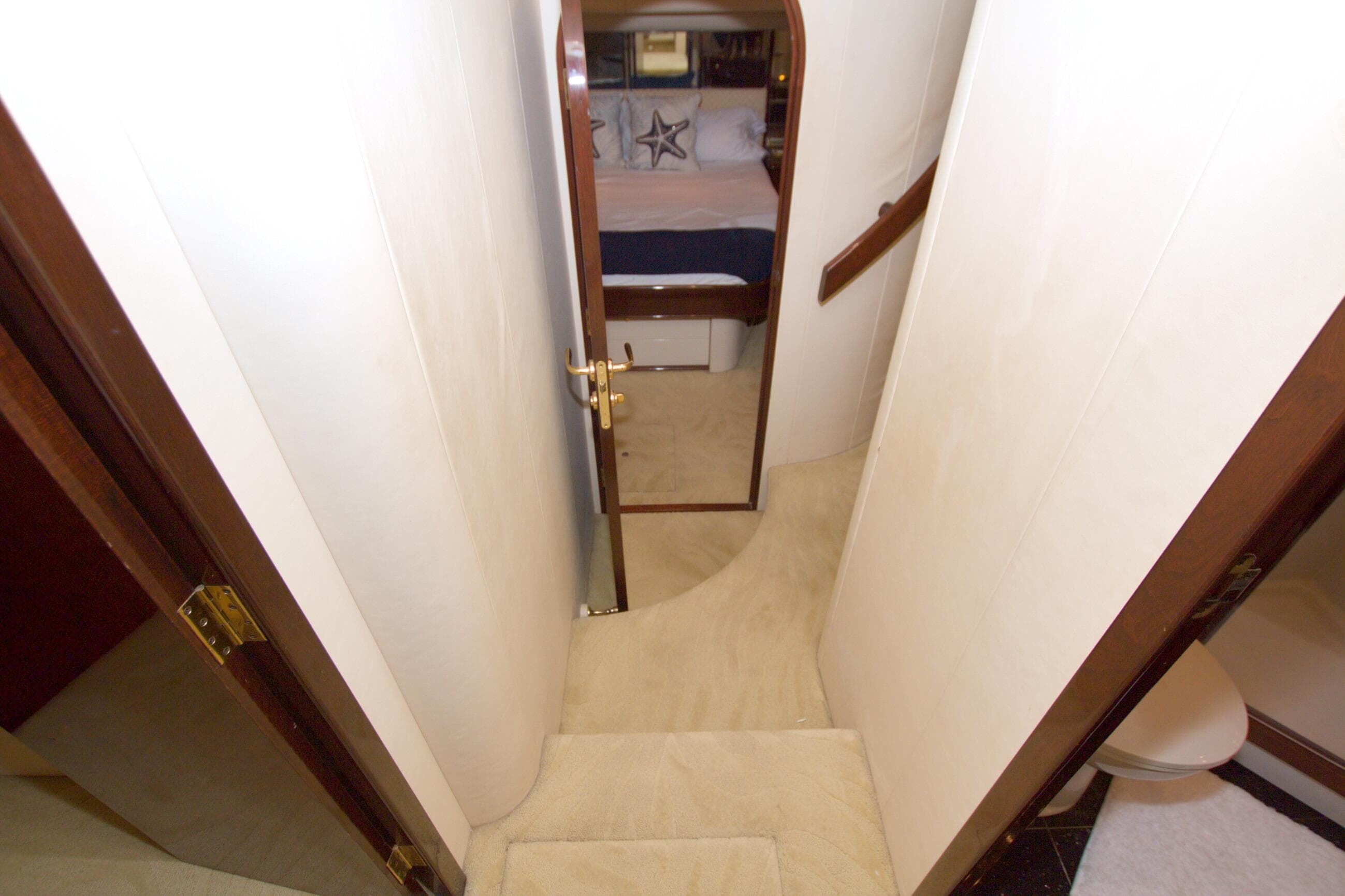 Interior hallway of 2005 Neptunus 62 Flybridge yacht, leading to bedroom.