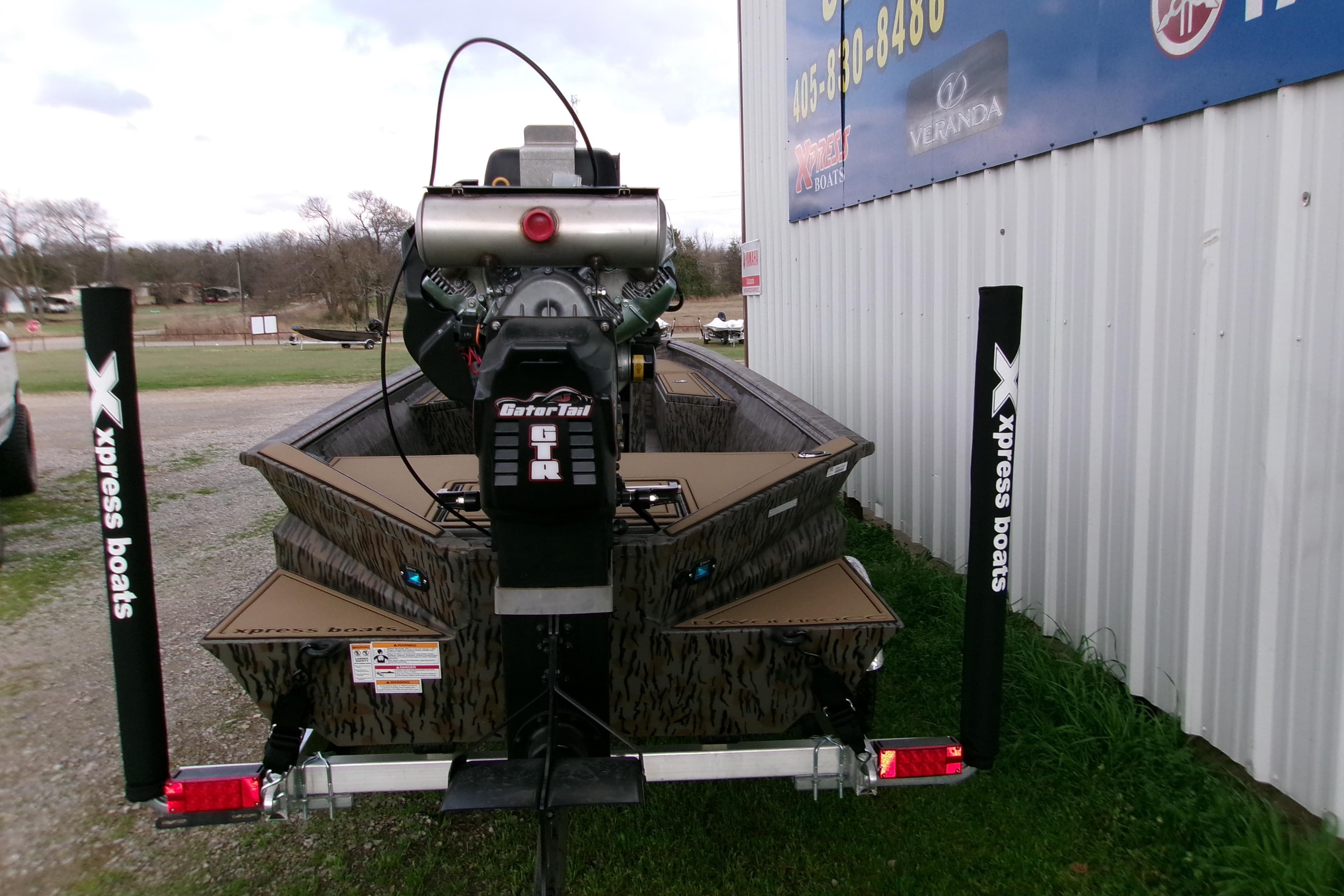 2026 Xpress Bayou 180CC boat with GatorTail motor, parked outside dealership.