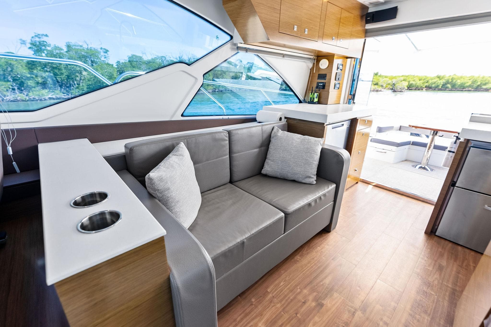 Luxurious interior of 2019 Cruisers Yachts 54 Cantius with modern seating and scenic views.