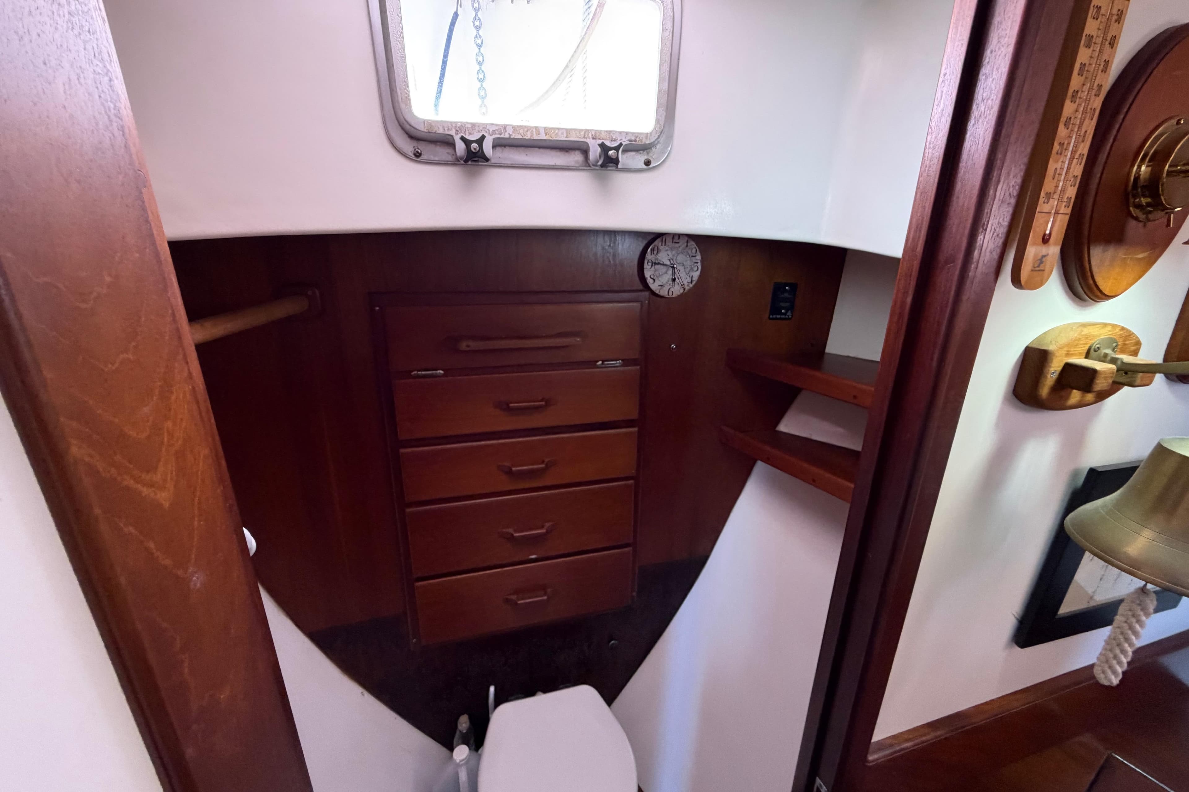 Interior of 1985 Gozzard PILGRIM boat with wooden cabinetry and nautical decor.