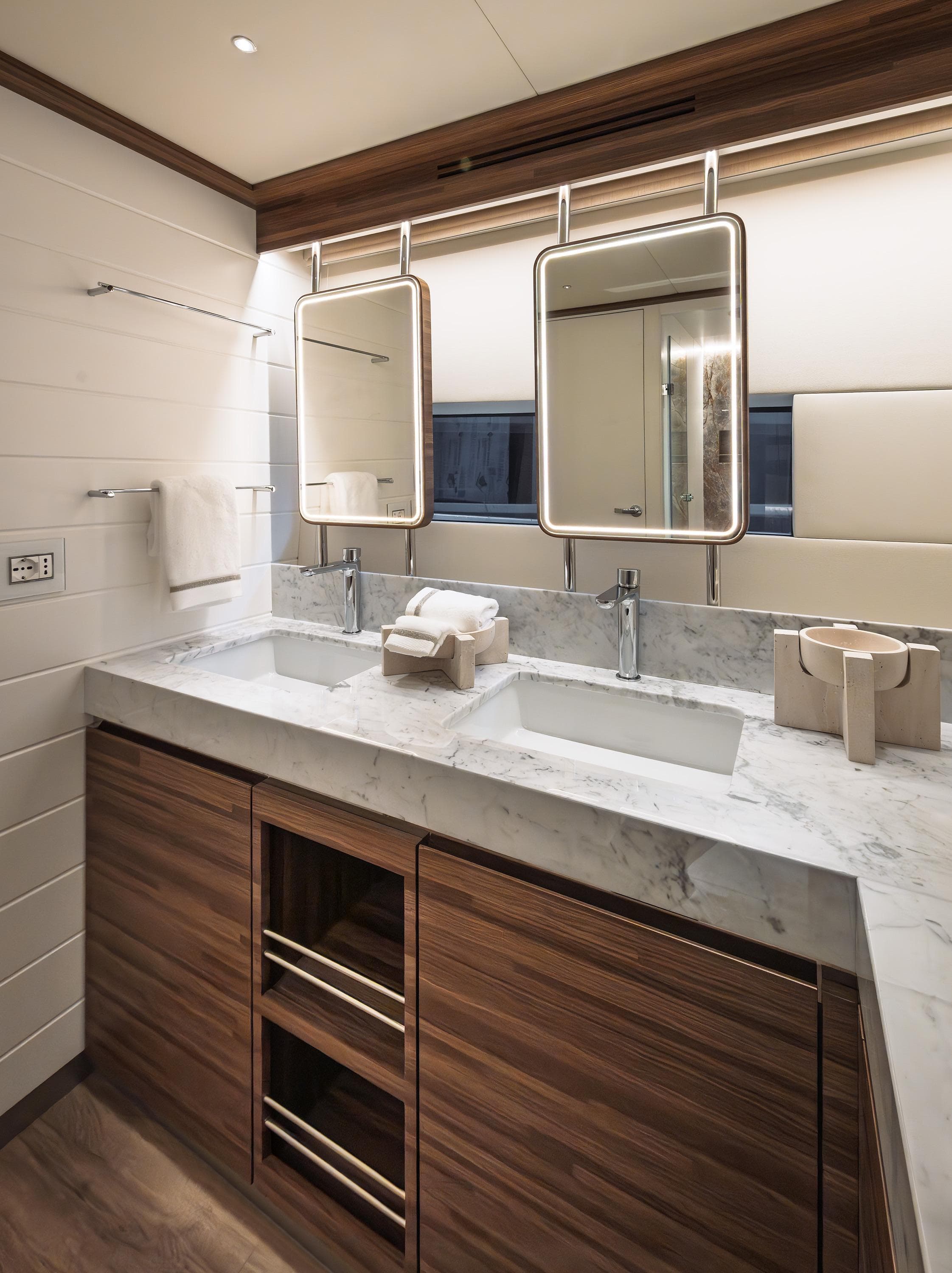 Luxurious VisionF E-Cat 80 yacht bathroom with dual sinks and elegant wood accents, 2025 model.