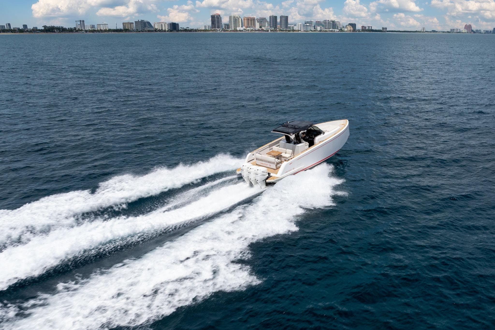 2021 Pardo Yachts 38 cruising on open water with city skyline in background.