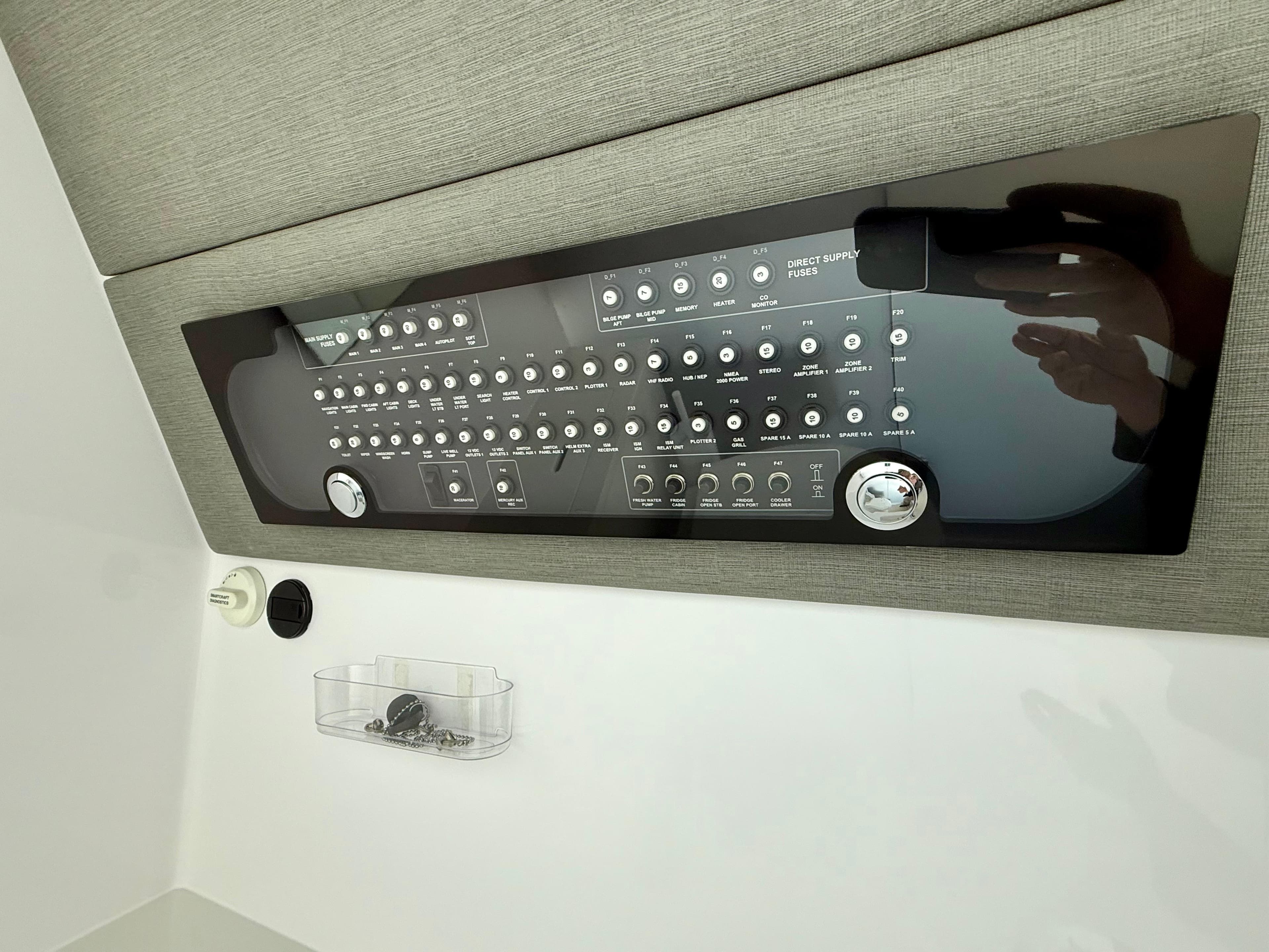 Control panel of a 2021 Axopar 37 boat, featuring various switches and dials.