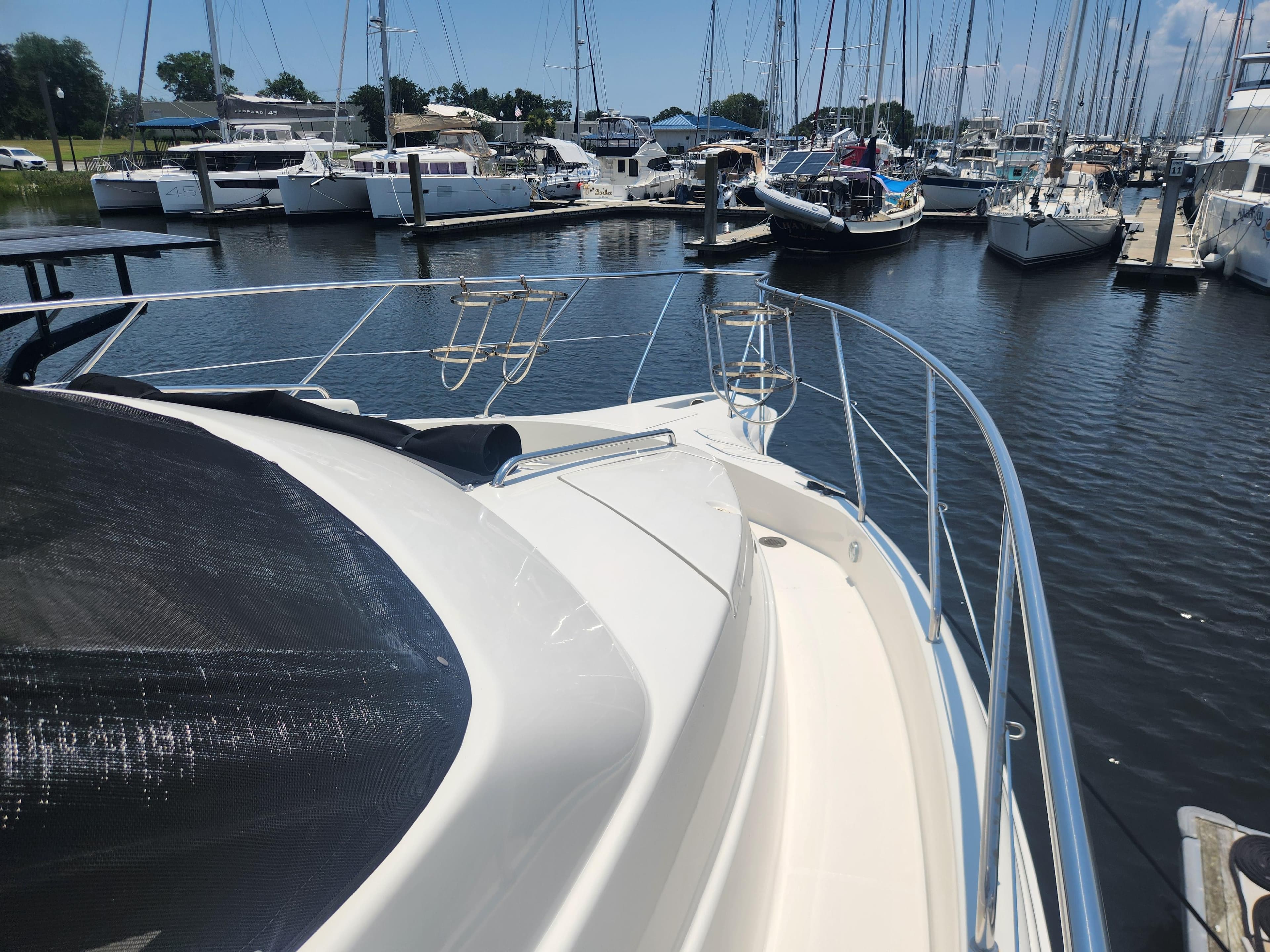 2000 Silverton 453 Motor Yacht docked in a marina, surrounded by sailboats.