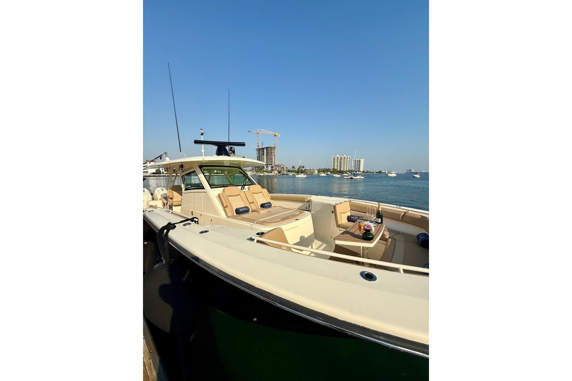 2024 Scout 400 LXF luxury boat docked with scenic waterfront view.