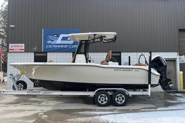 2026 Key West 239 FSR boat on trailer, parked outside a marine dealership.