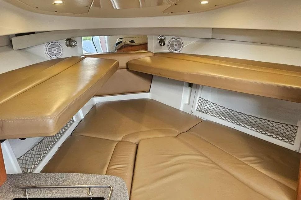 Interior cabin of 2007 Sailfish 30-06 Express boat with tan seating and storage.
