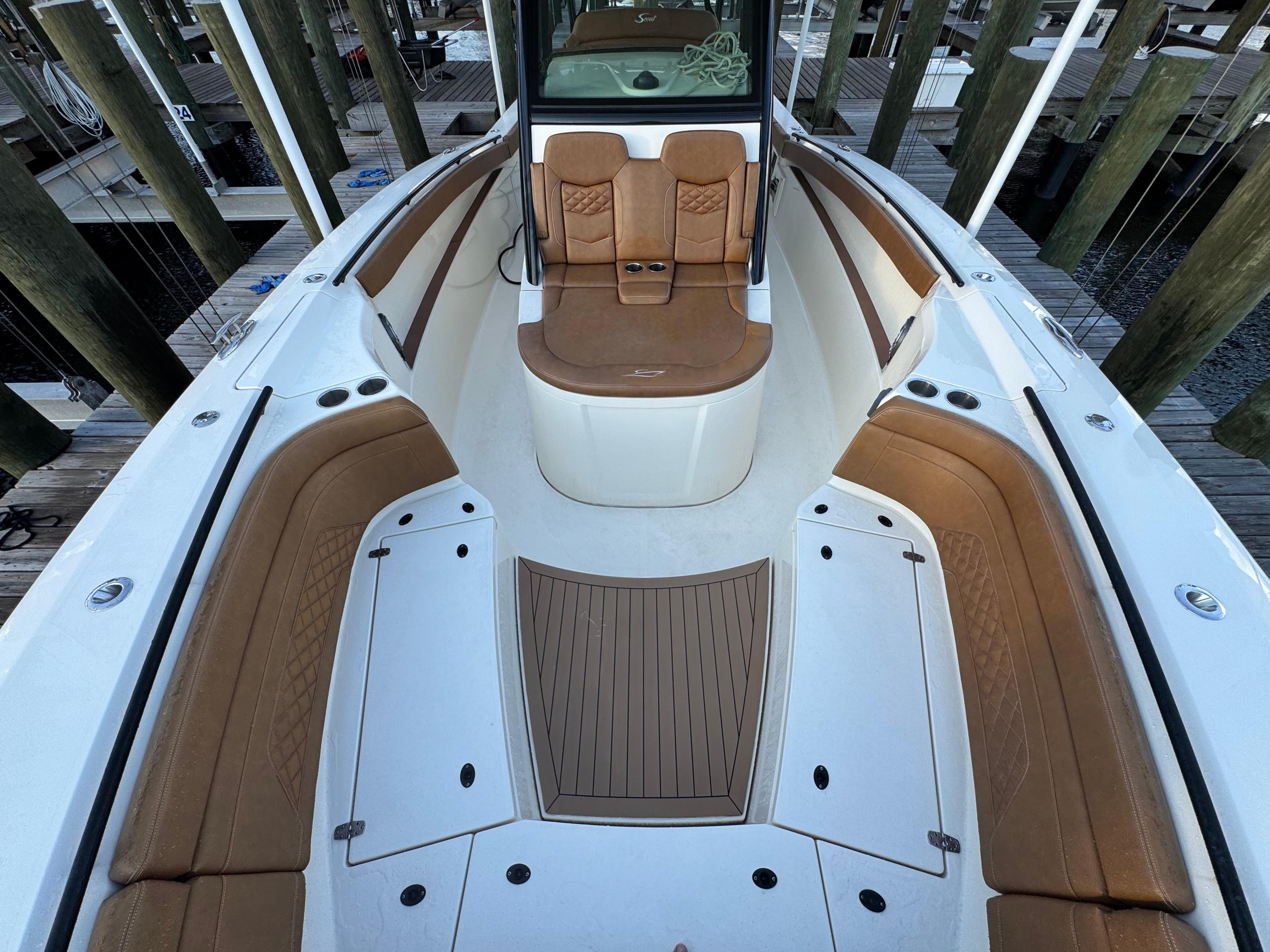 2021 Scout 330 LXF boat interior with tan seating and white deck, docked at marina.