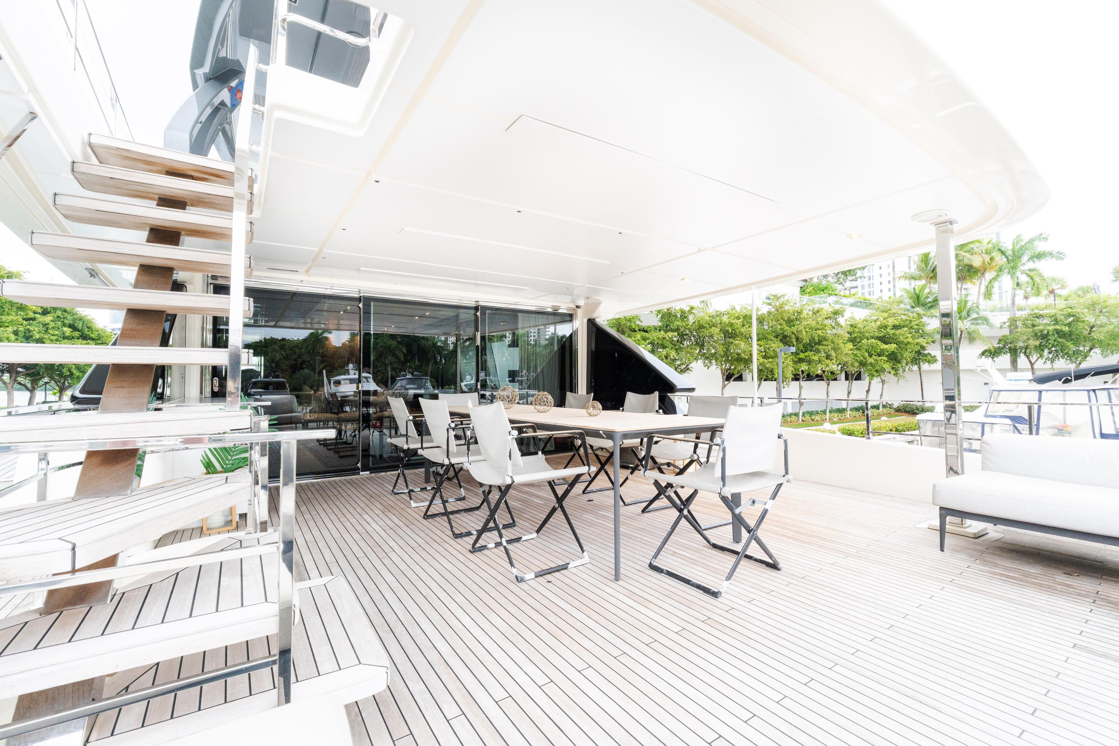 Luxurious outdoor deck of 2018 Custom Line Navetta 33 yacht with seating and stairs.