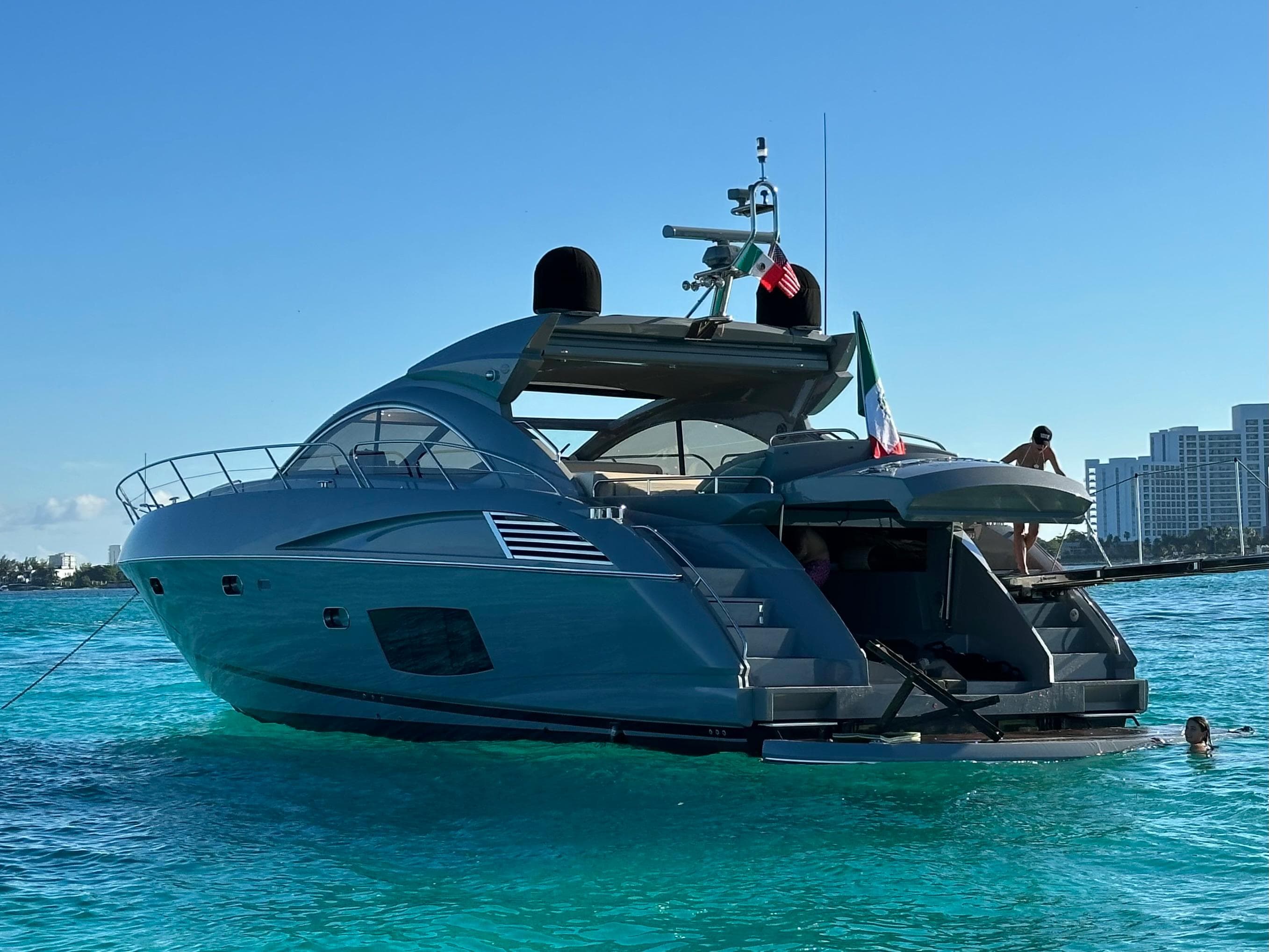 2011 Sunseeker Predator 60 yacht on clear blue water, sunny day.