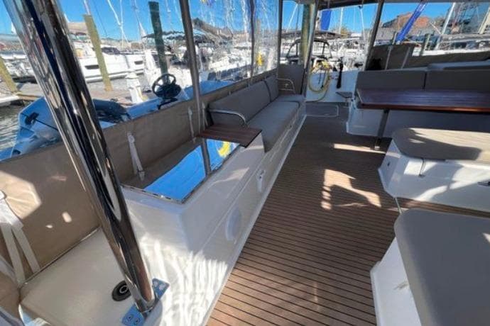 2024 Fountaine Pajot Aura 51 Catamaran interior with spacious seating and wooden flooring.