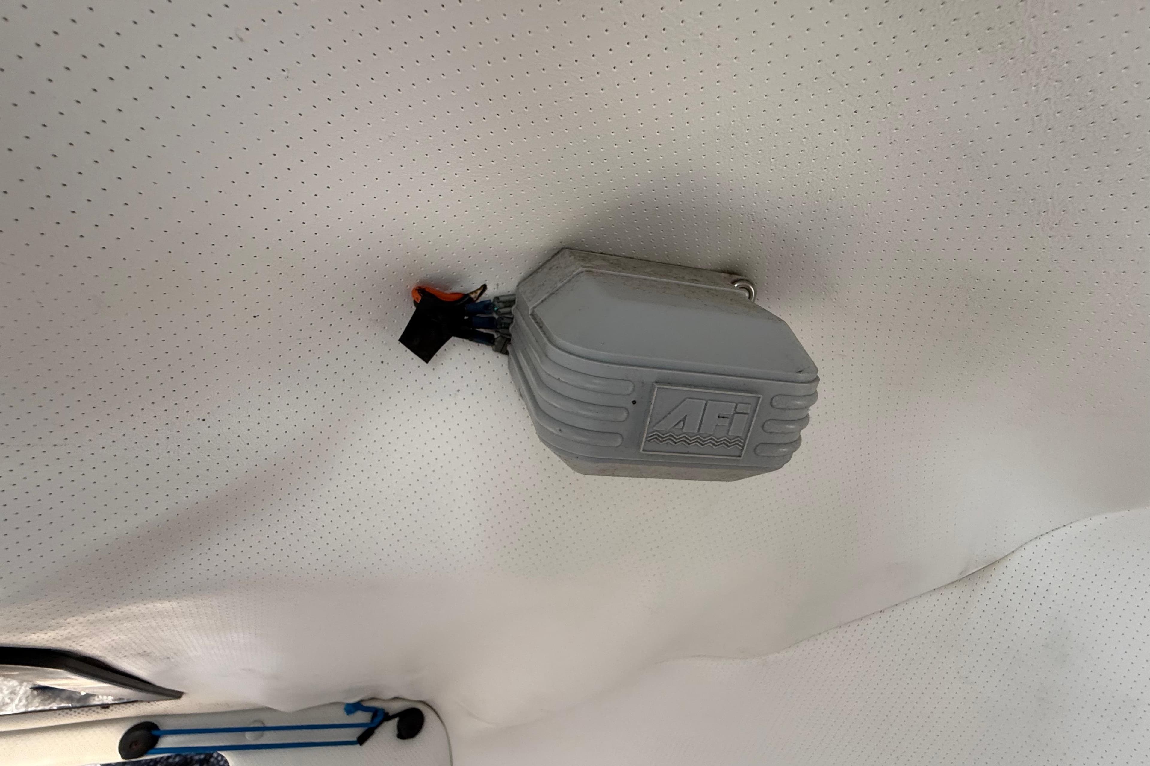 Ceiling-mounted device inside 2000 Sport-Craft 241 Walk Around boat cabin.