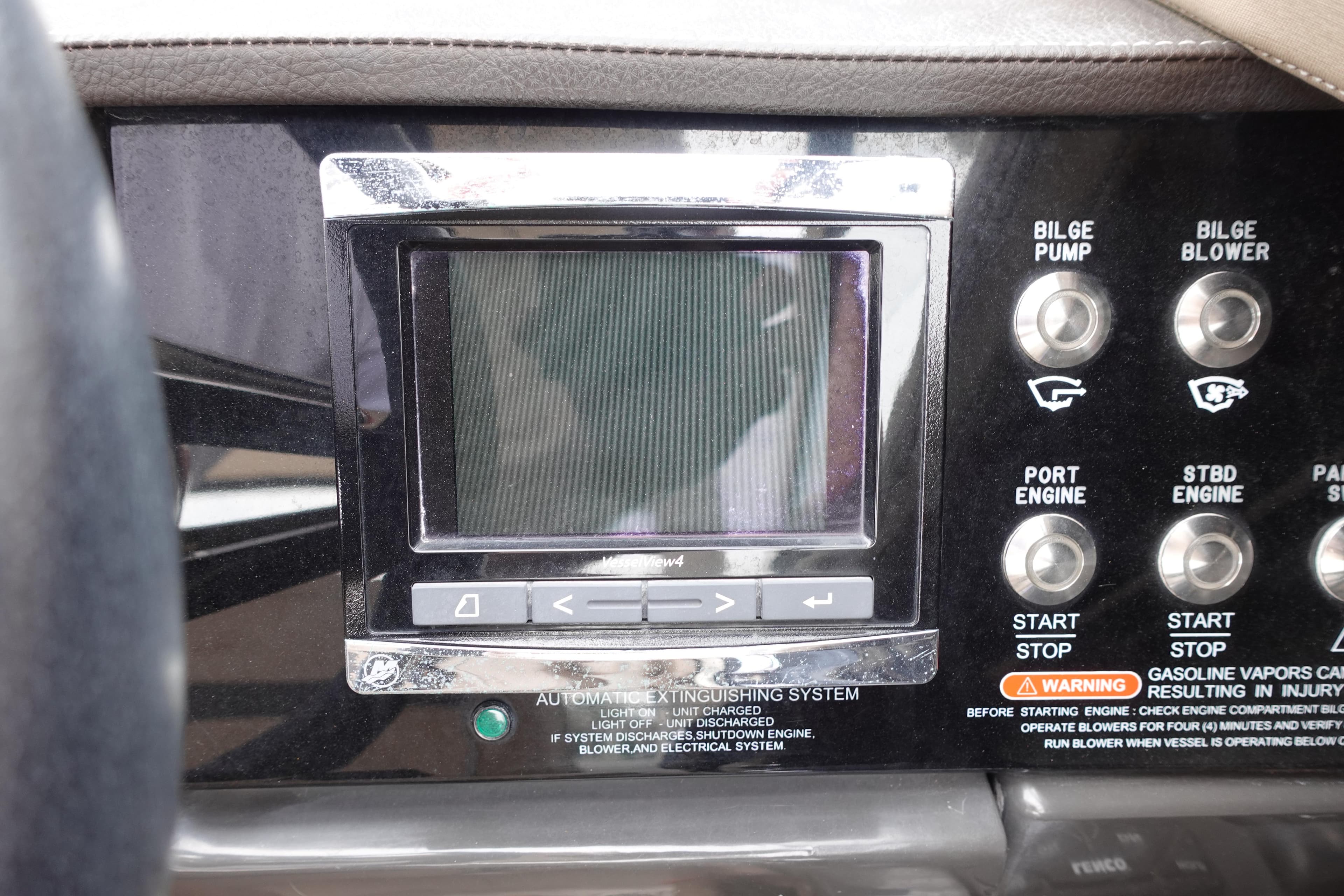 Control panel of a 2017 Sea Ray SLX 310 boat with display and engine controls.